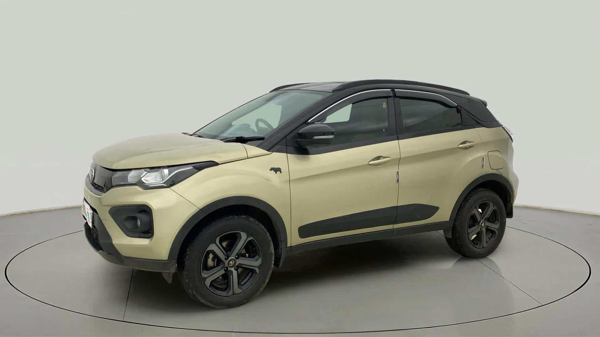 Front side view of a Grassland Beige Tata Nexon 2017-2023