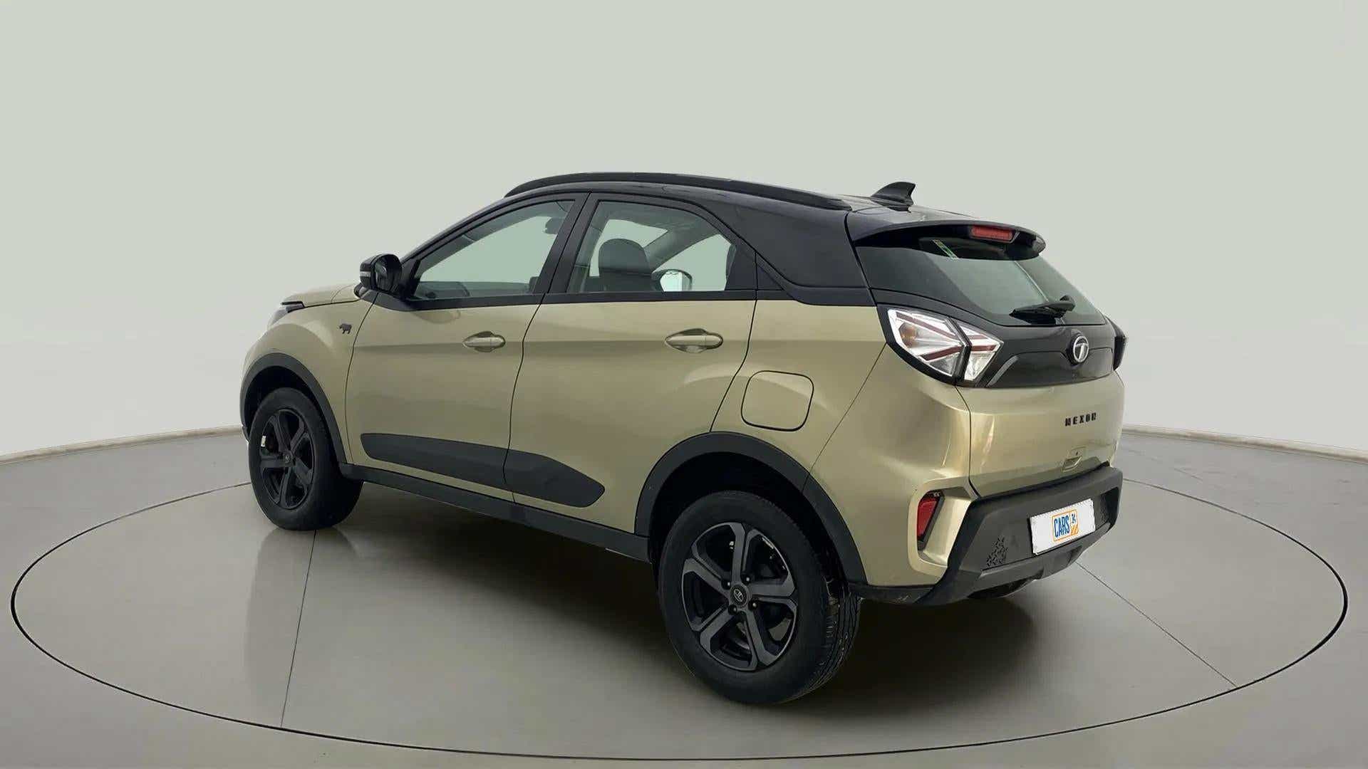 Rear three-quarter view of a Grassland Beige Tata Nexon 2017-2023
