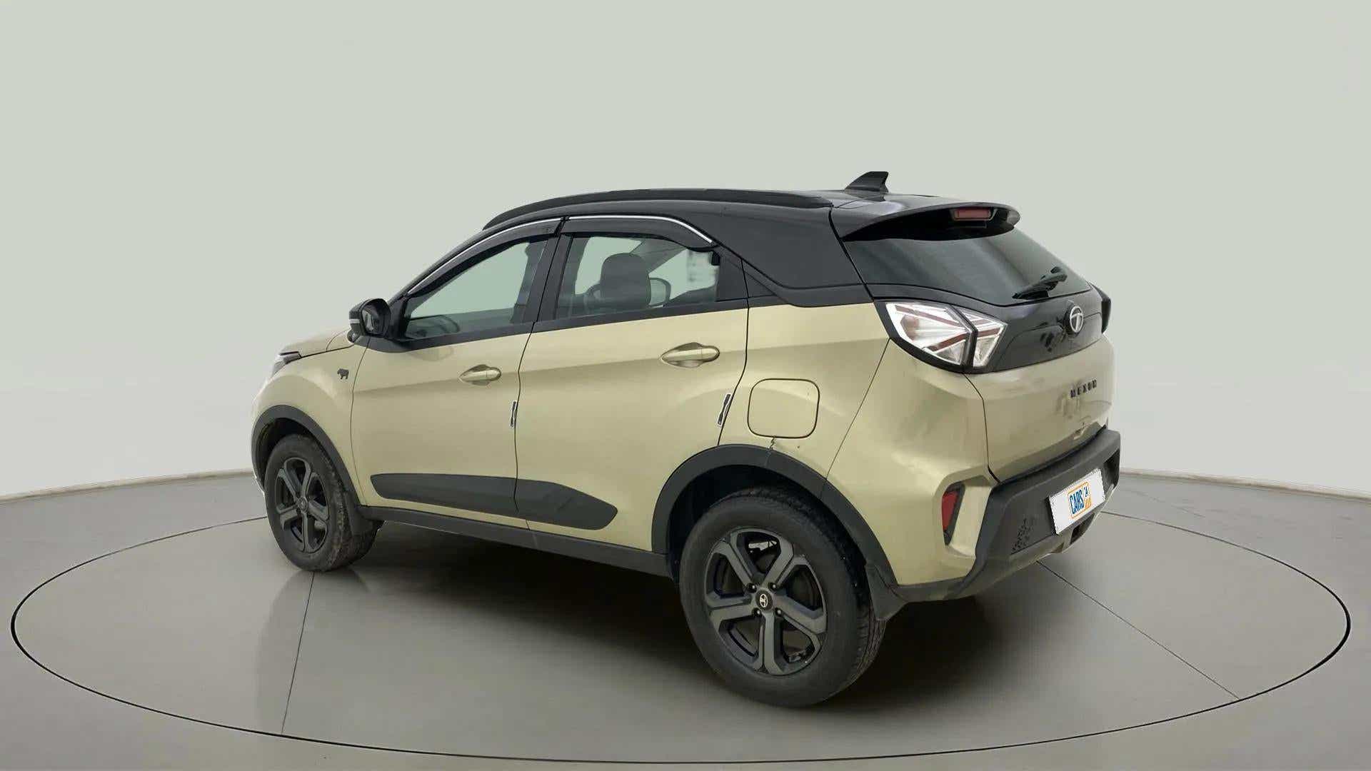 Rear three-quarter view of a Grassland Beige Tata Nexon 2017-2023