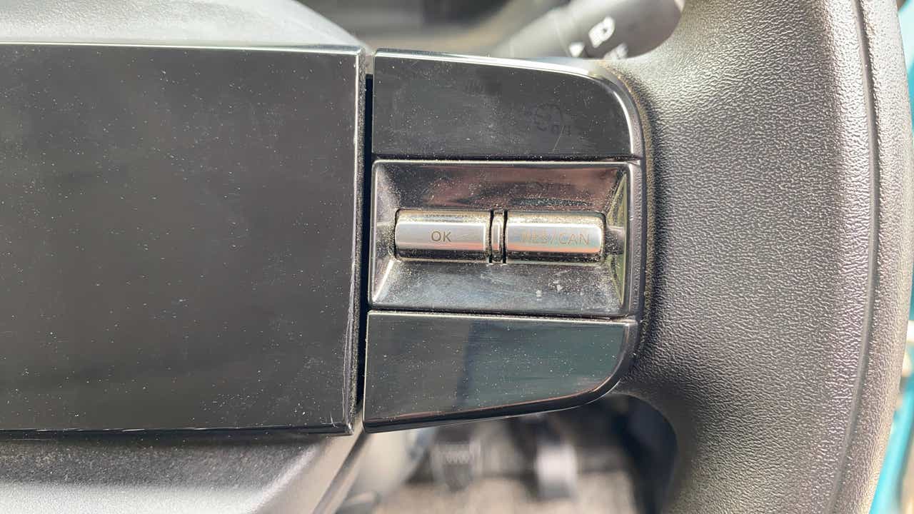 Close-up view of steering wheel buttons on a Tata Nexon