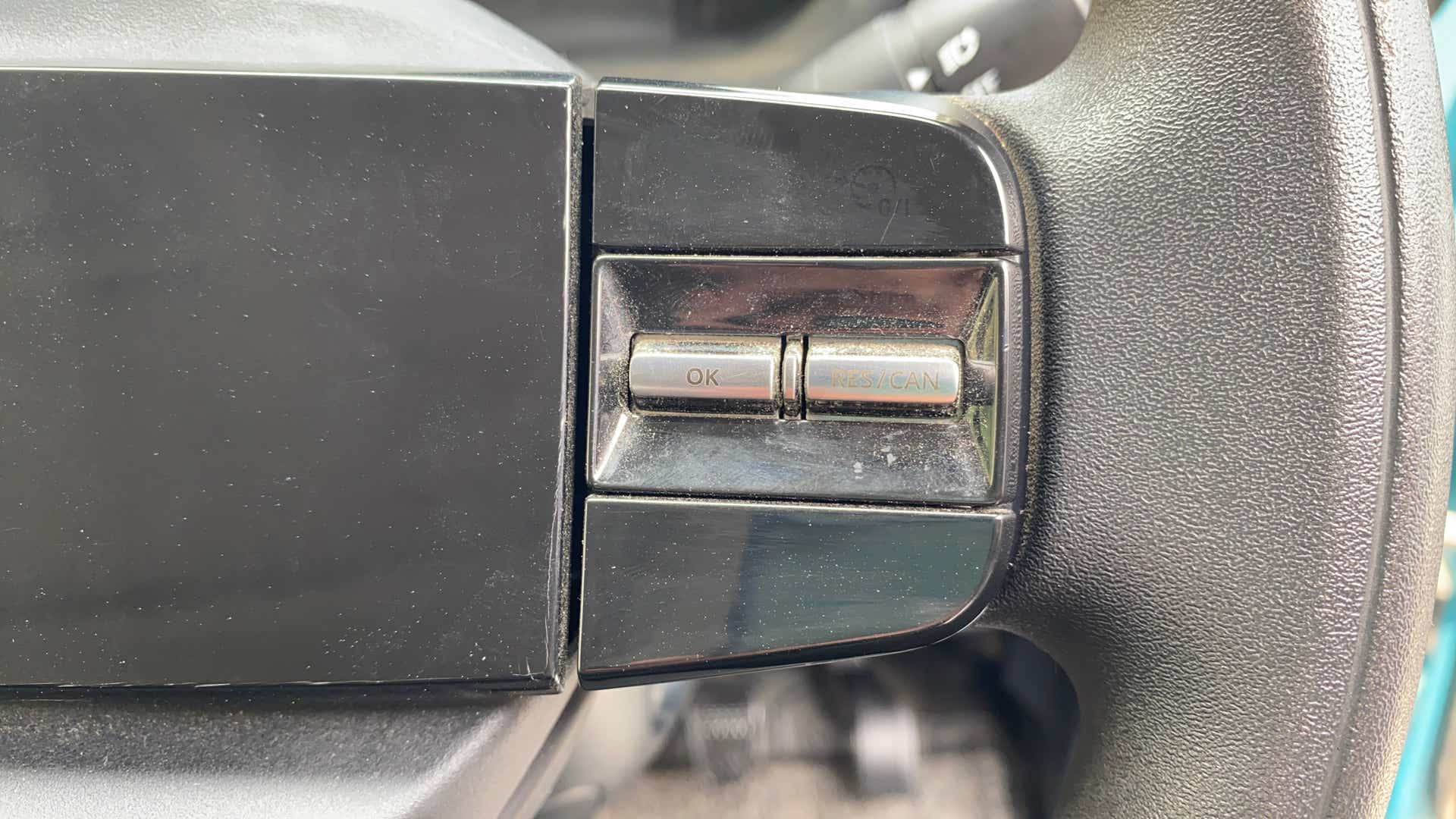 Close-up view of steering wheel buttons on a Tata Nexon
