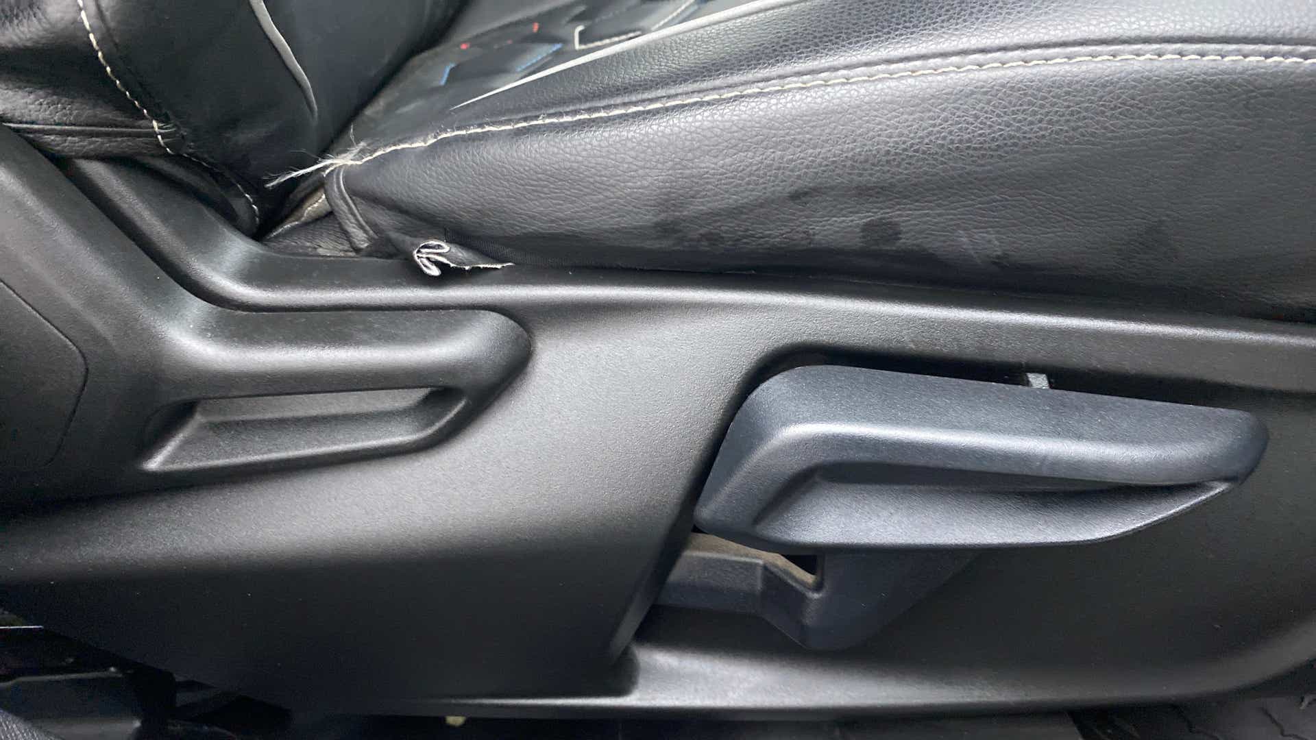 Driver seat adjustment lever of a Tata Nexon 2017-2023