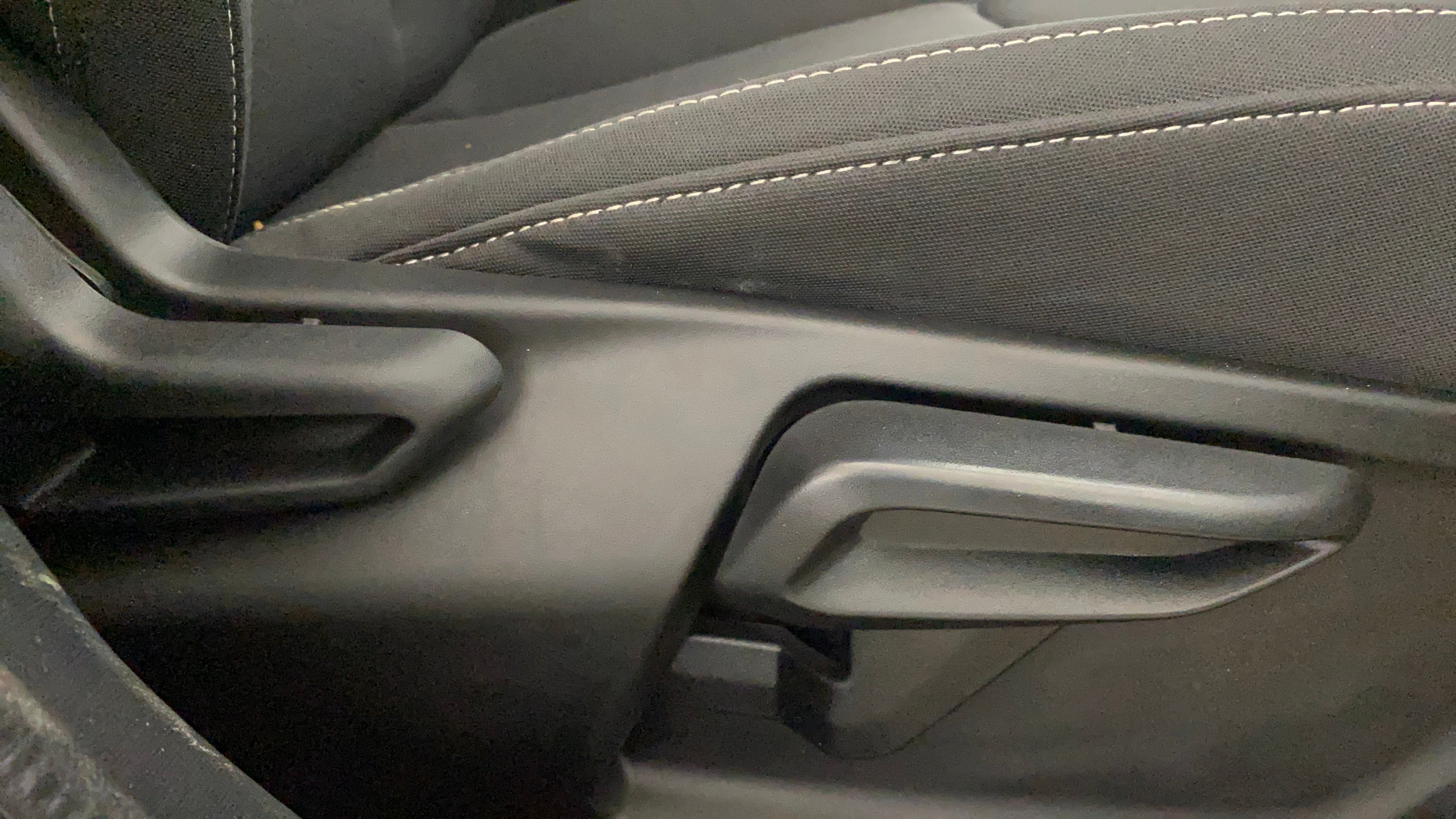Close-up of seat adjustment lever in a Tata Nexon