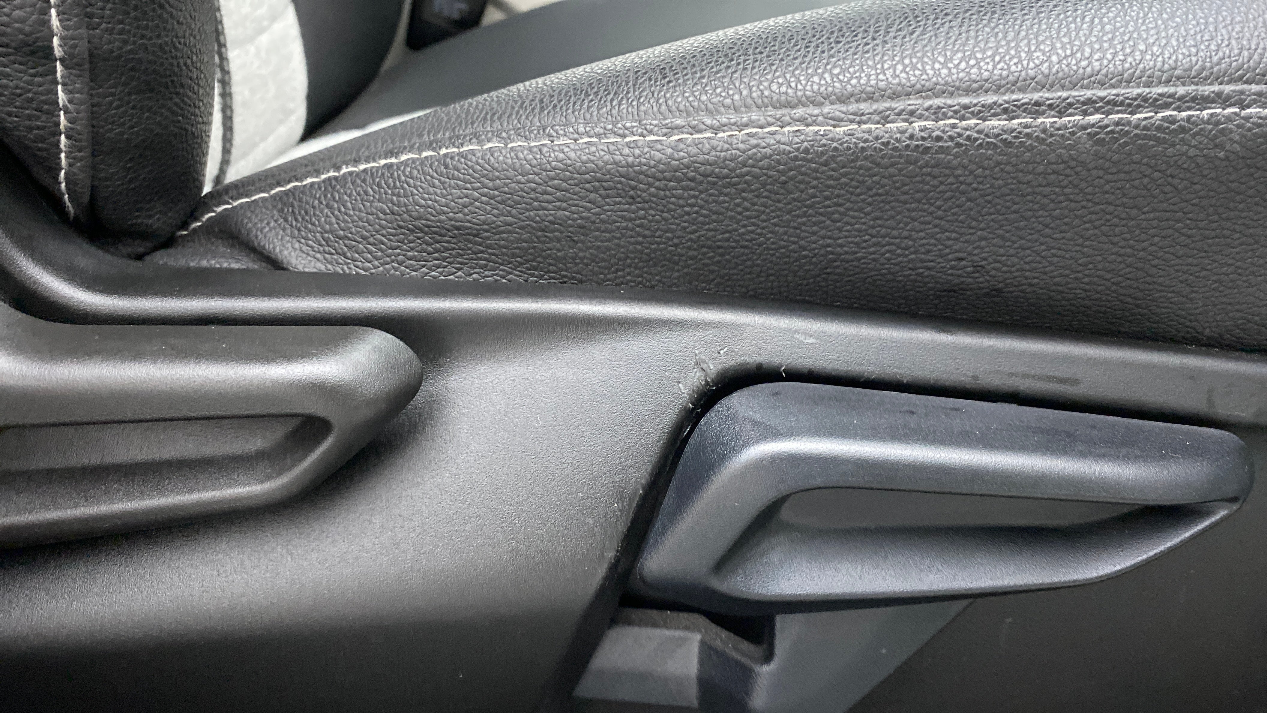 Close-up of a seat adjustment lever of a Tata Nexon 2017-2023