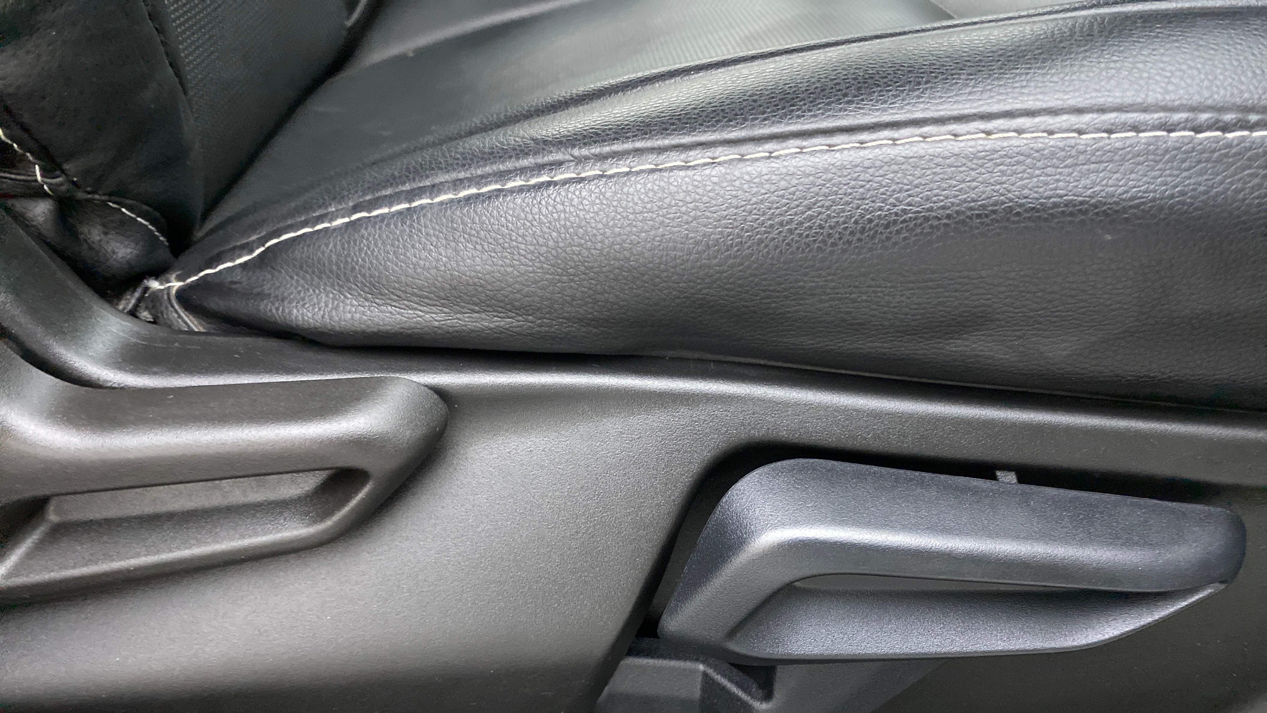 Close-up of a seat adjustment lever of a Tata Nexon 2017-2023