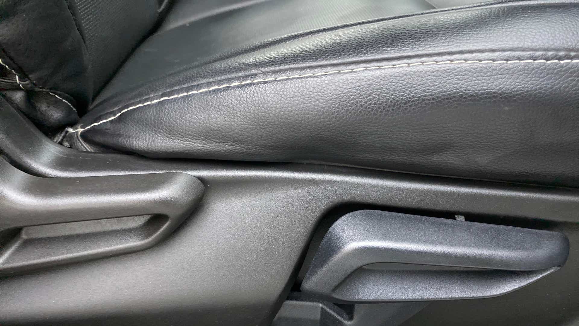 Close-up of a seat adjustment lever of a Tata Nexon 2017-2023