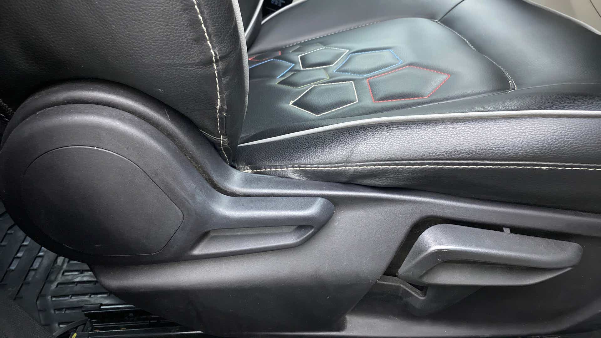 Close-up of a seat adjustment lever of a Tata Nexon 2017-2023