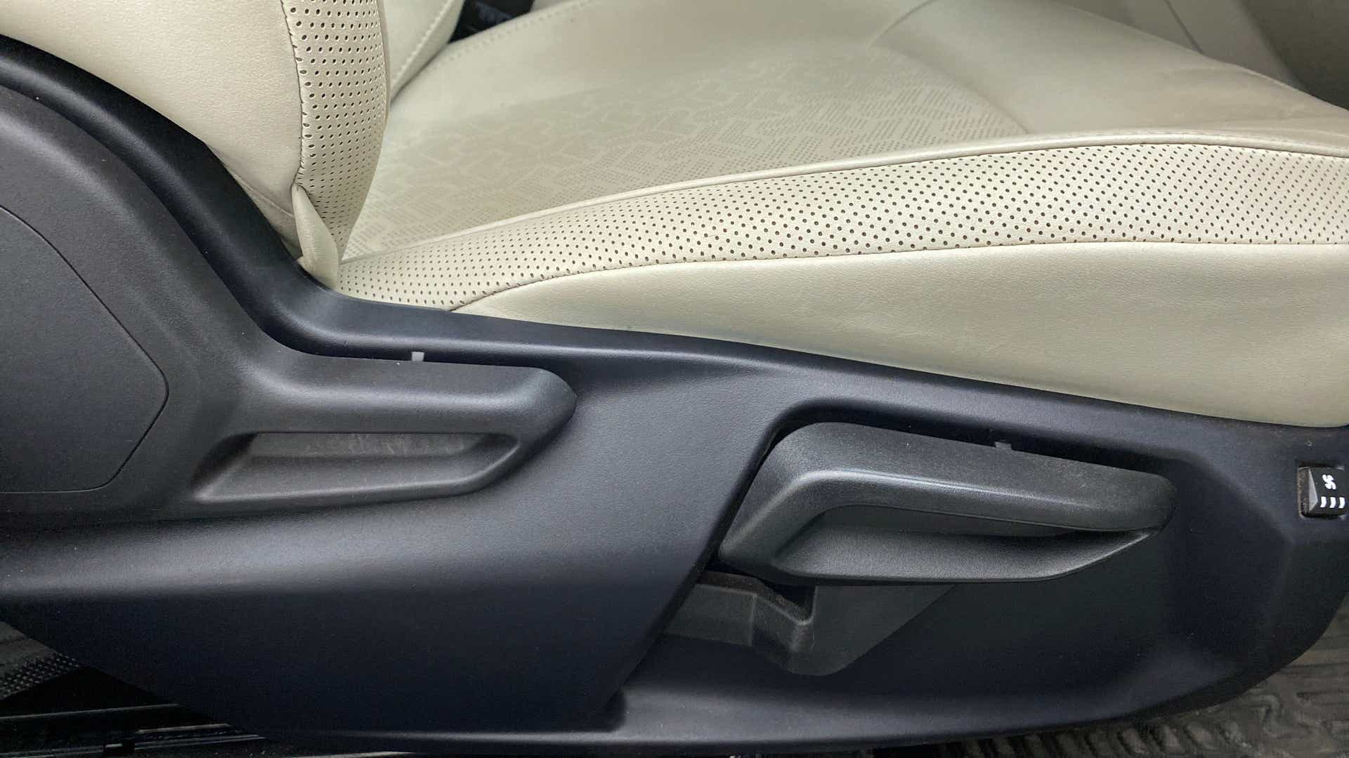 Close-up of a front seat adjustment lever of a Tata Nexon 2017-2023