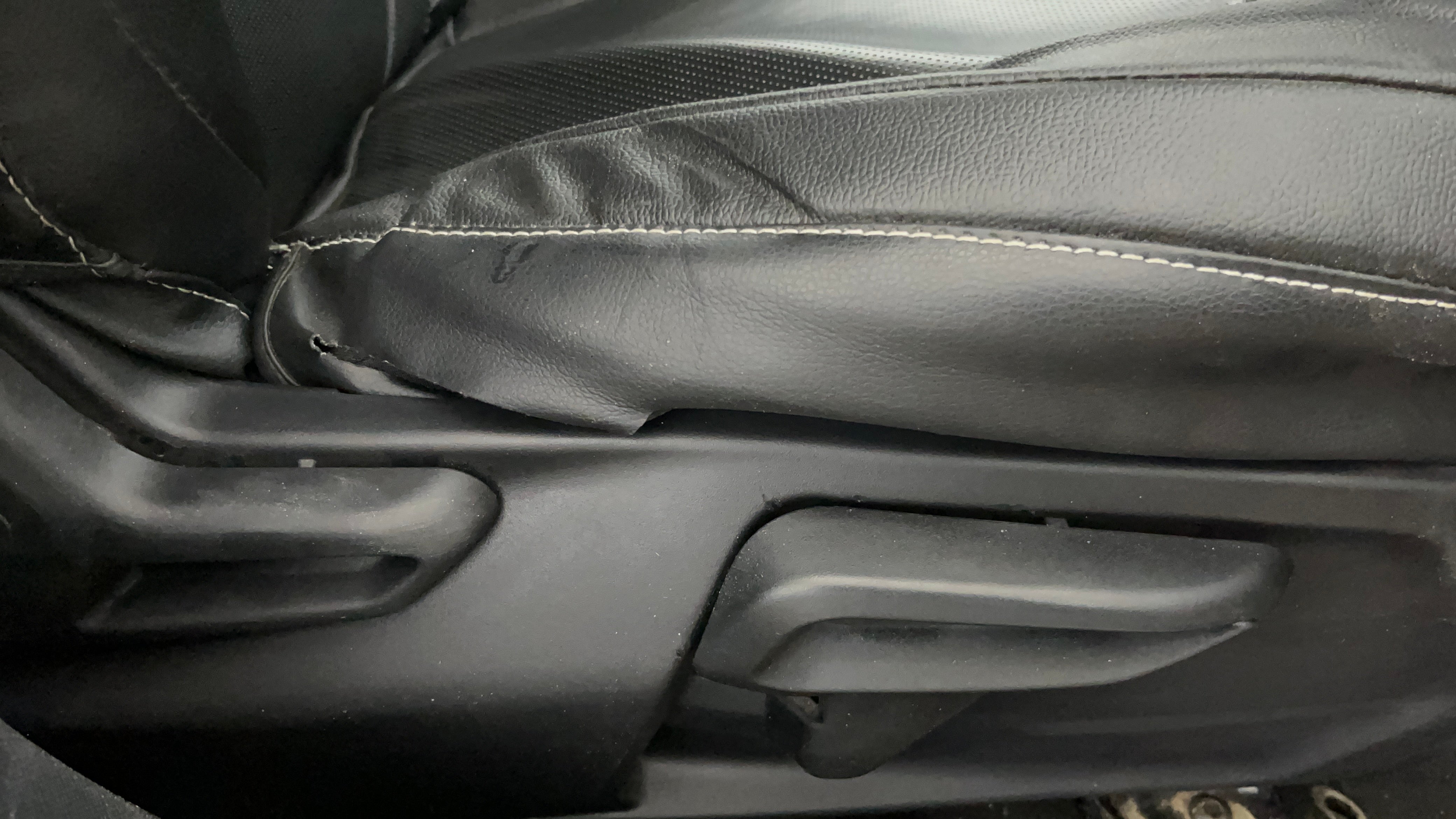 Close-up view of a Tata Nexon 2017-2023 seat adjustment lever