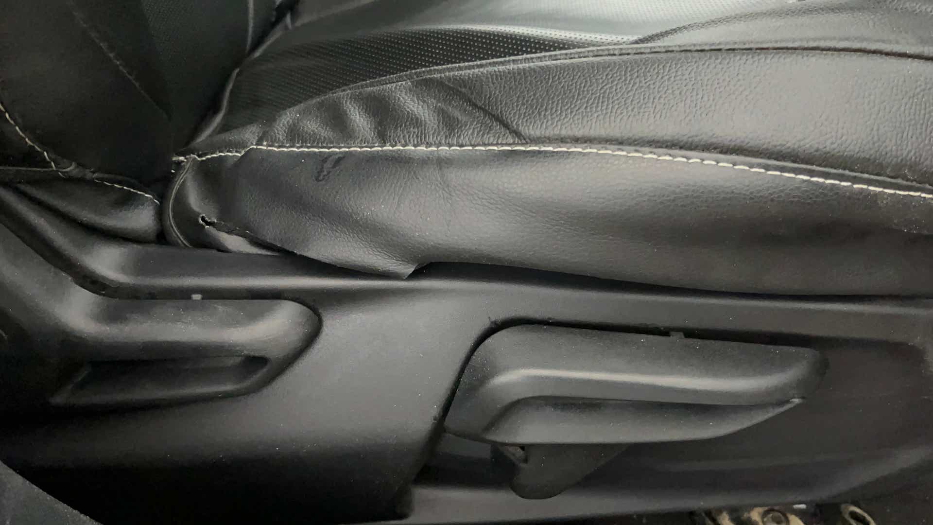 Close-up view of a Tata Nexon 2017-2023 seat adjustment lever