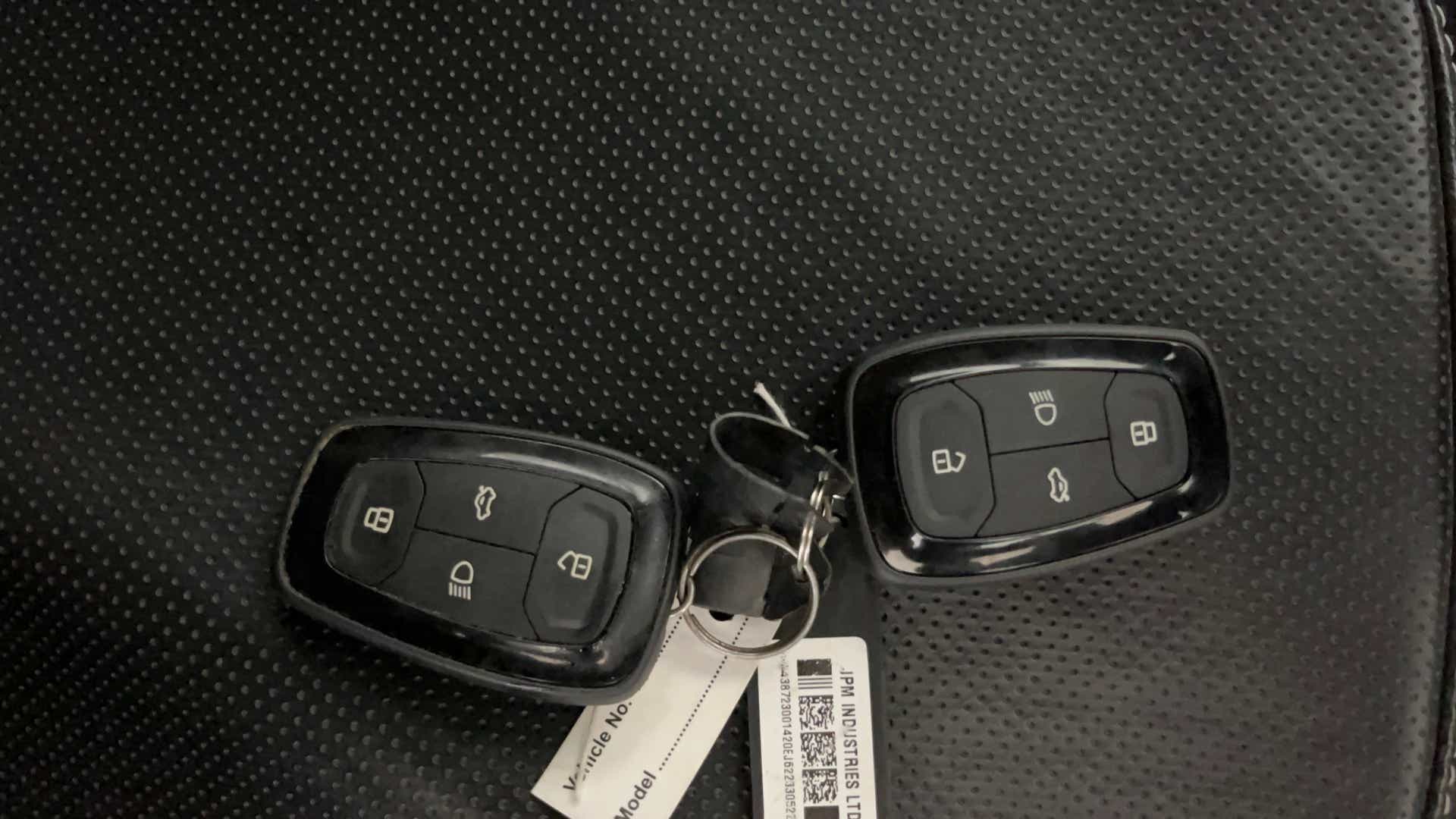 Car key fobs on a seat of a Tata Nexon 2017-2023