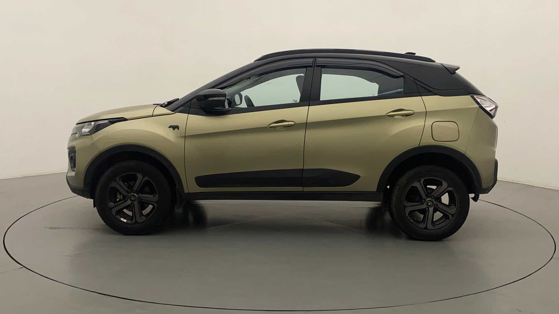 Side view of a grassland beige Tata Nexon 2017-2023