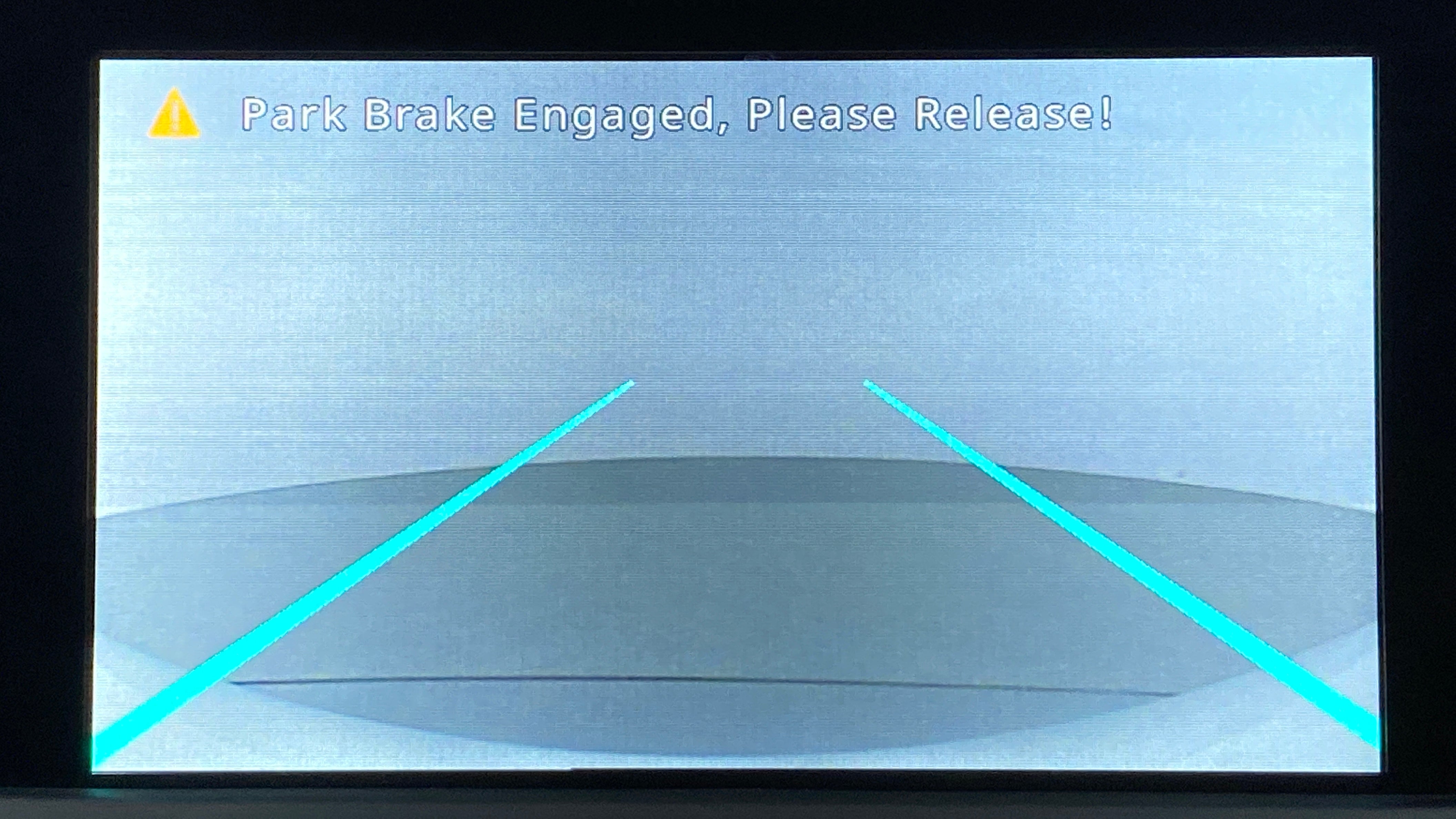 Reverse camera display with park brake warning on a Tata Nexon 2017-2023