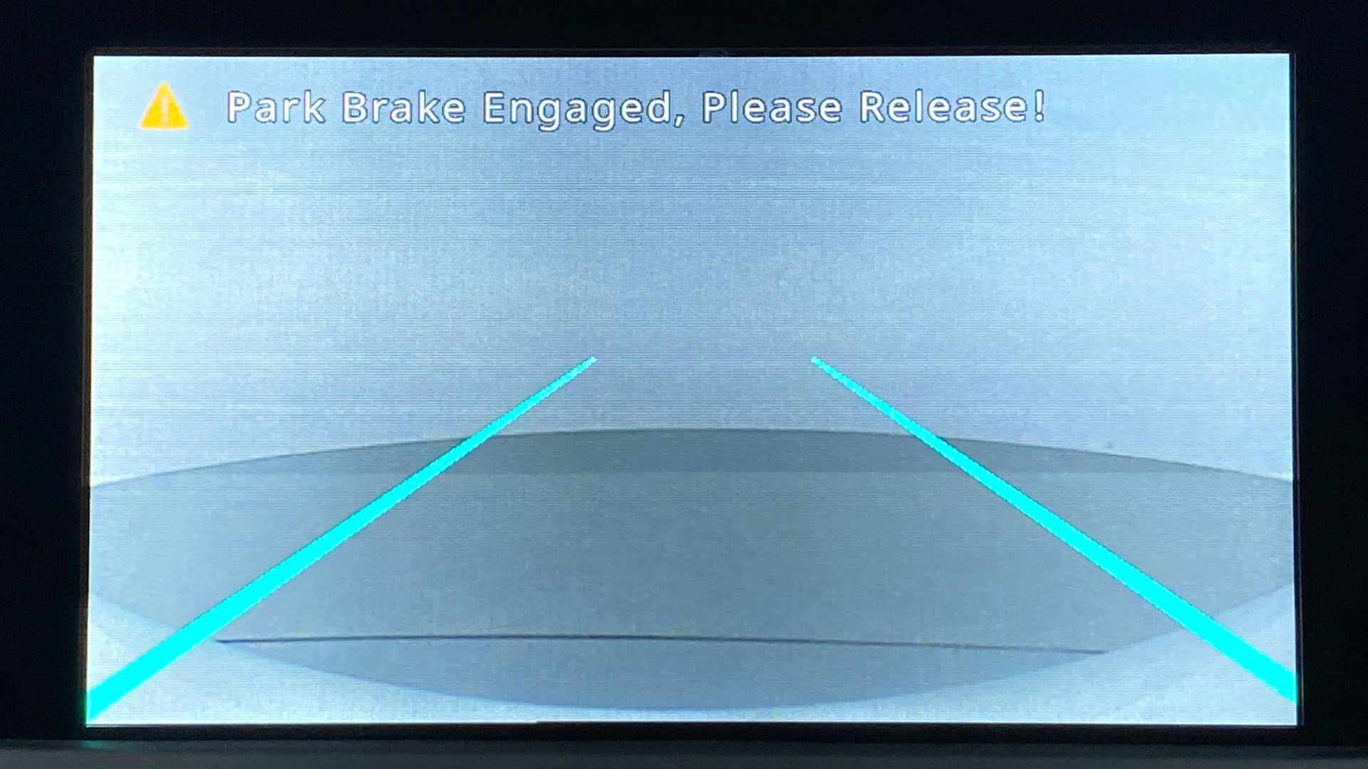 Reverse camera display with park brake warning on a Tata Nexon 2017-2023
