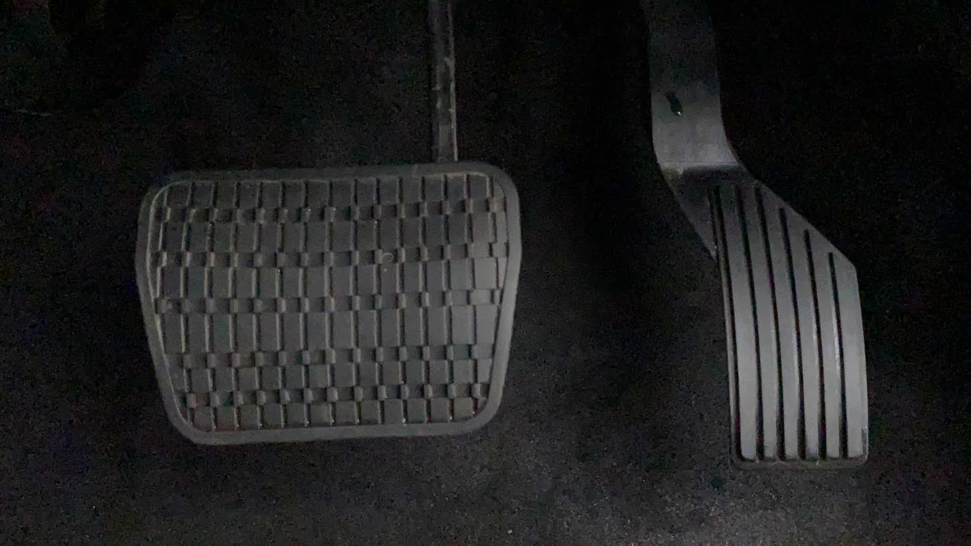 Close-up view of the foot pedals of a Tata Nexon 2017-2023