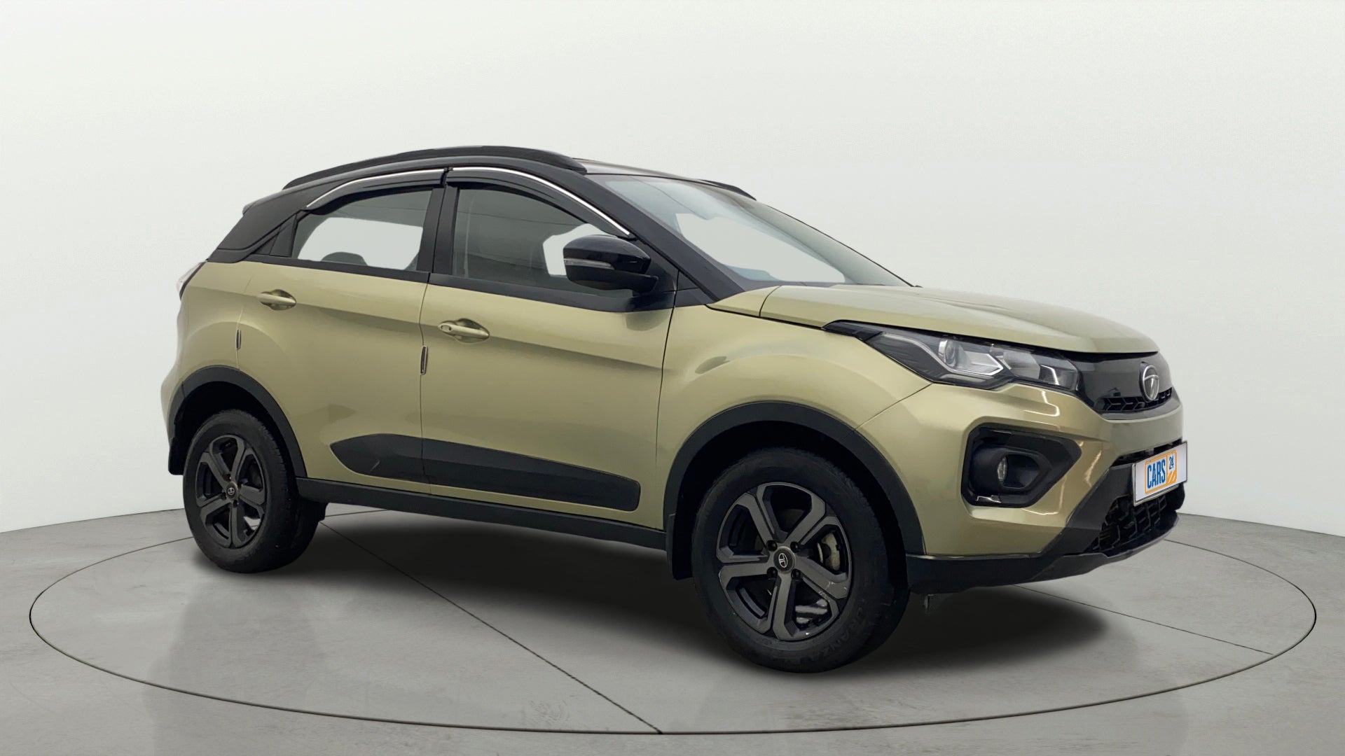 Front side view of a Grassland Beige Tata Nexon 2017-2023