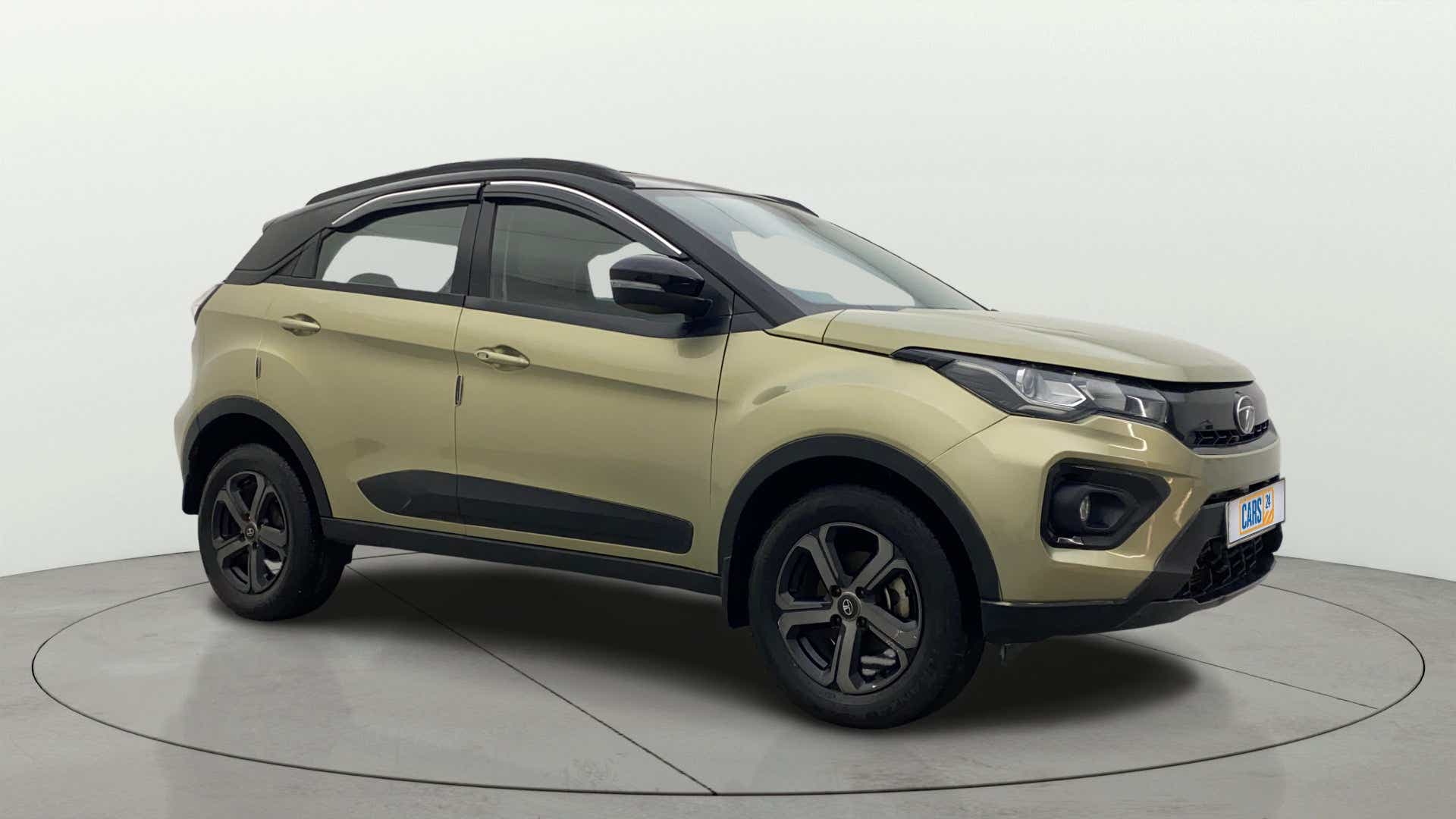 Front side view of a Grassland Beige Tata Nexon 2017-2023