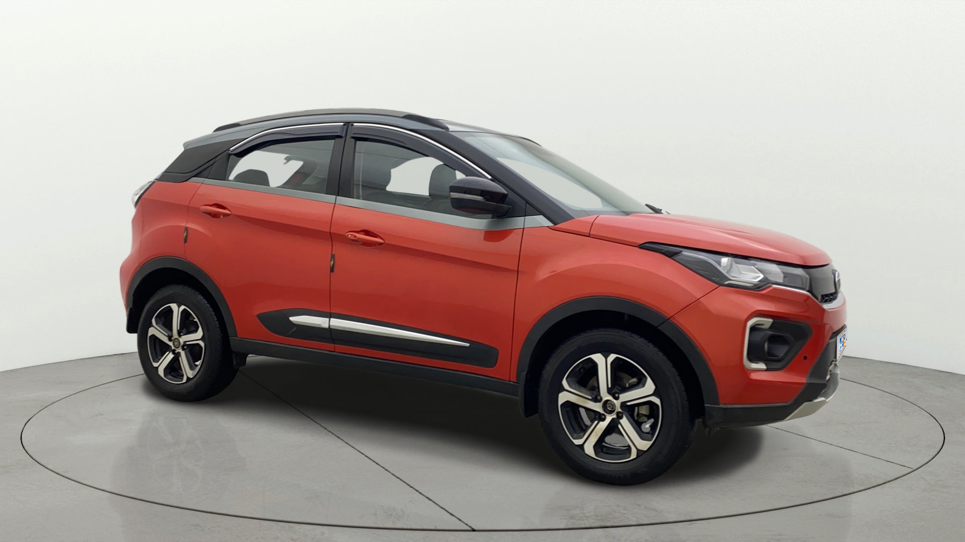 Side view of a flame red Tata Nexon 2017-2023