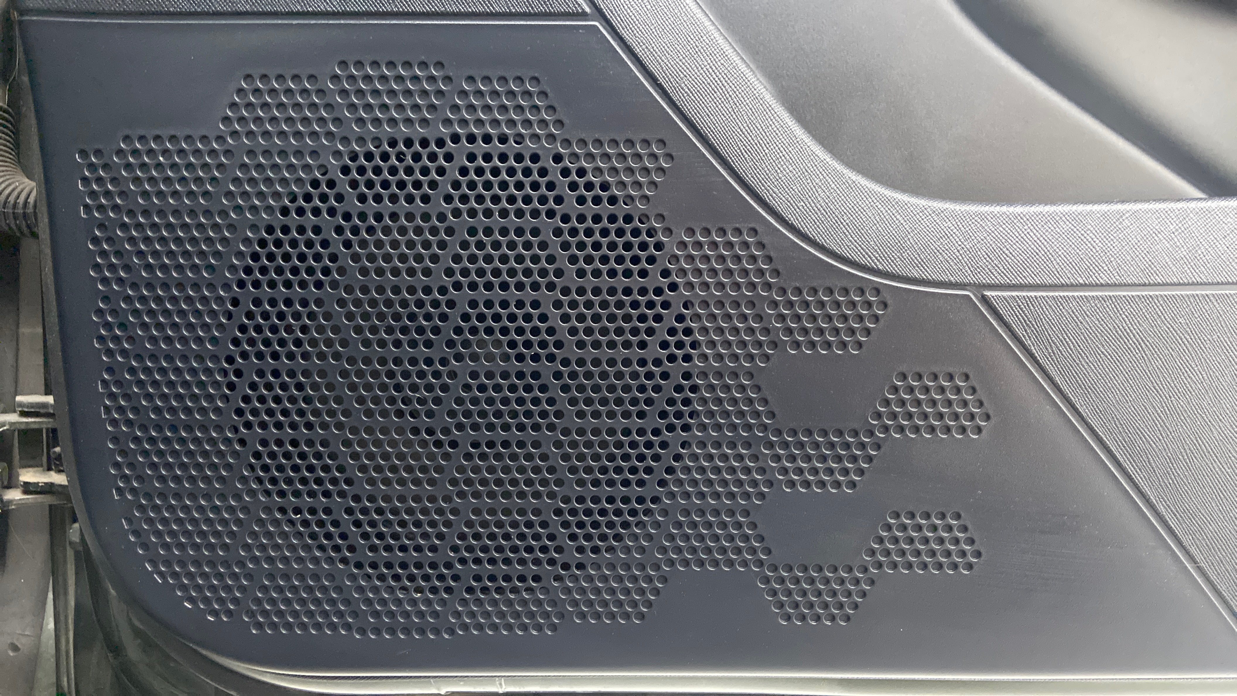Close-up of a door speaker grille of a Tata Nexon 2017-2023