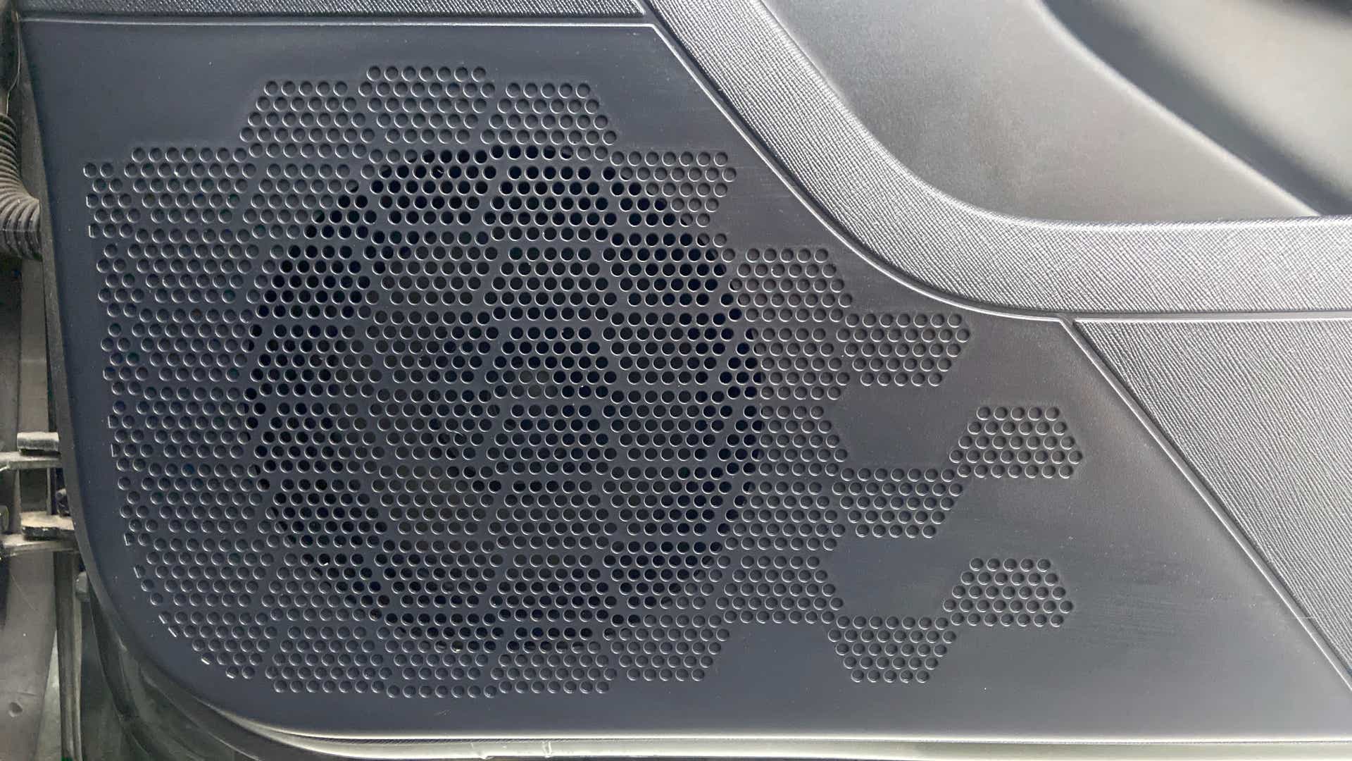 Close-up of a door speaker grille of a Tata Nexon 2017-2023