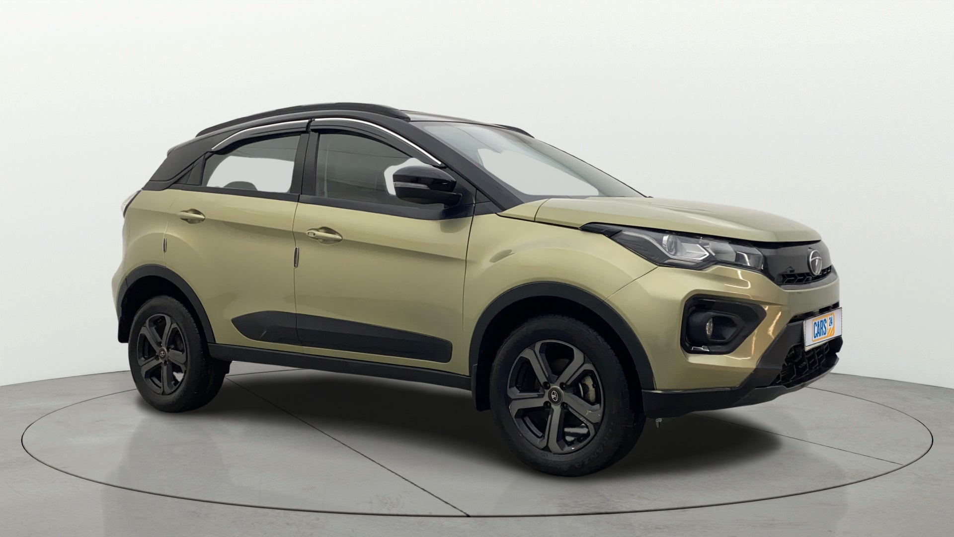 Front three-quarter view of a Grassland Beige Tata Nexon 2017-2023
