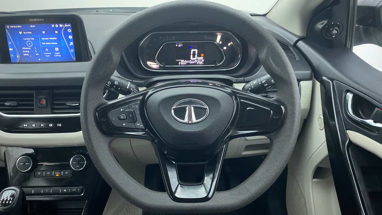 Steering wheel and dashboard view of a Tata Nexon 2017-2023