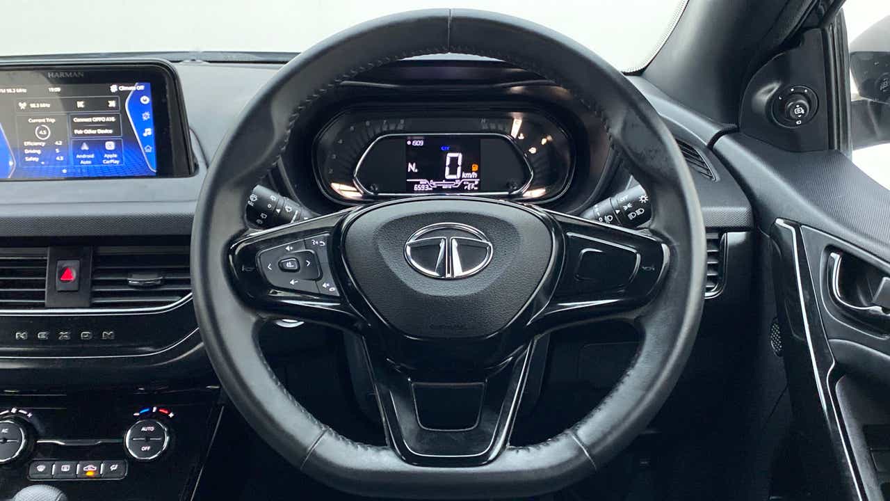 Steering wheel and dashboard view of a Tata Nexon 2017-2023