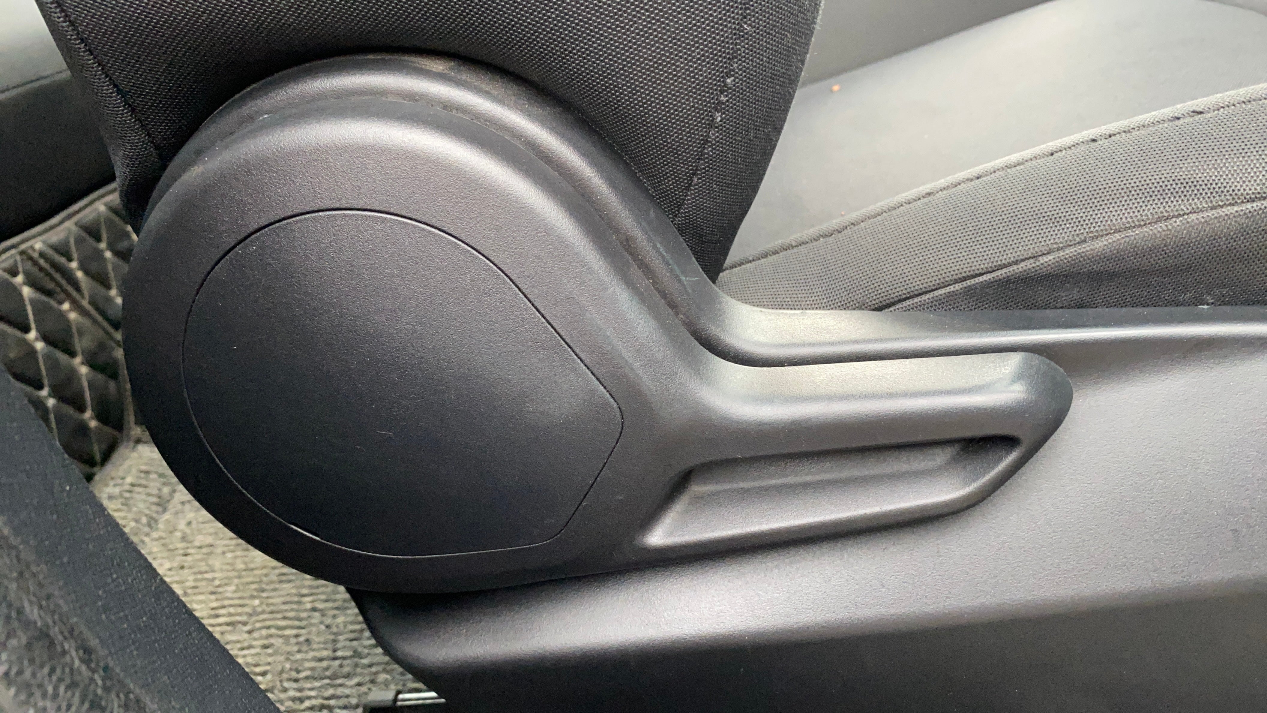 Close-up of a seat adjustment lever of a Tata Nexon