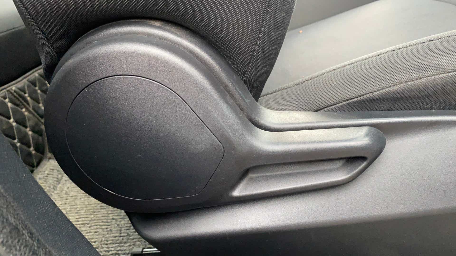 Close-up of a seat adjustment lever of a Tata Nexon