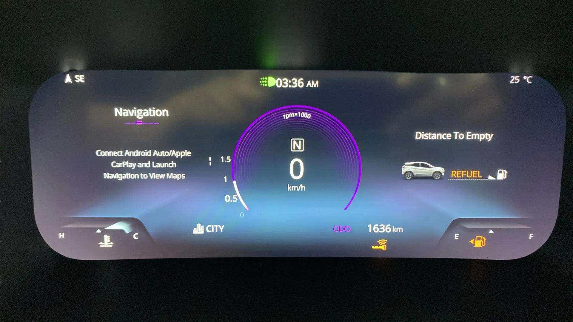 Digital instrument cluster of a Tata Nexon displaying navigation, speedometer and fuel status
