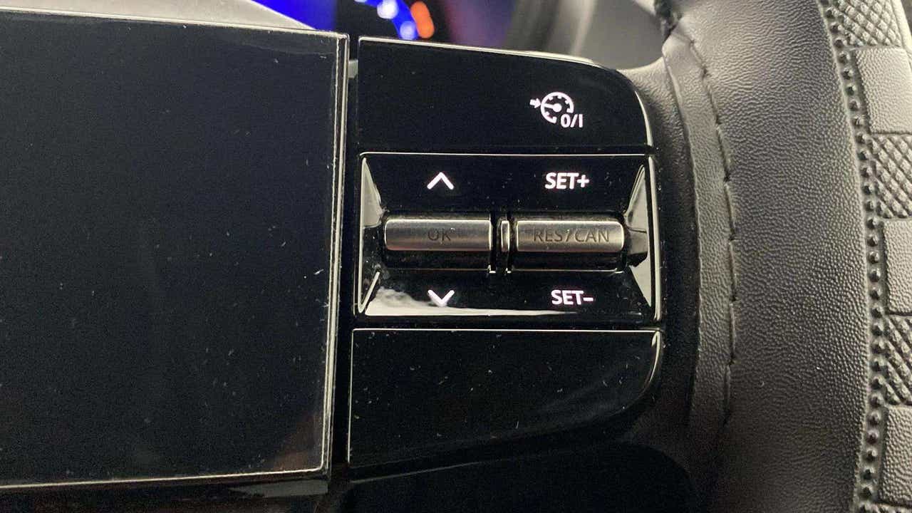 Steering wheel cruise control buttons of a Tata Nexon