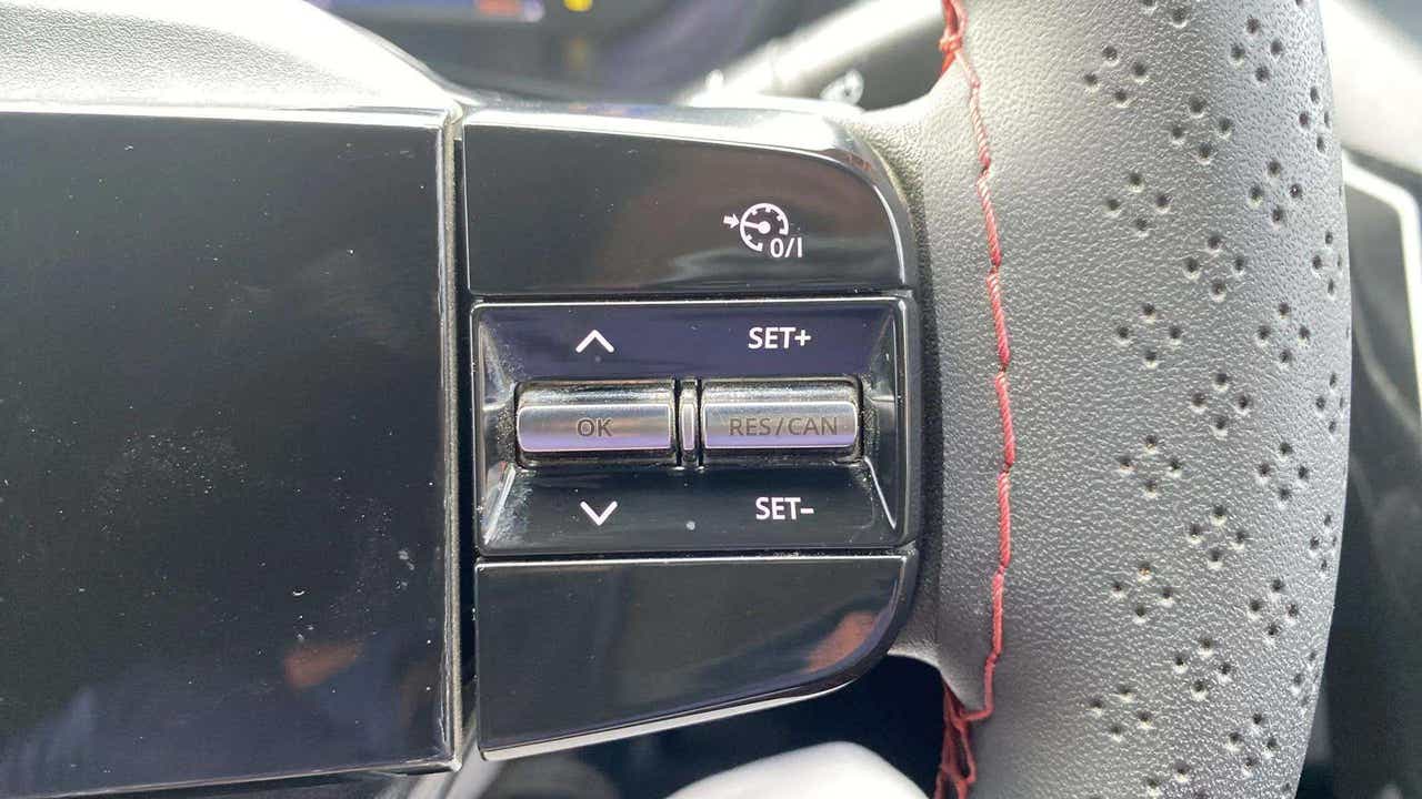 Steering wheel cruise control buttons of a Tata Nexon