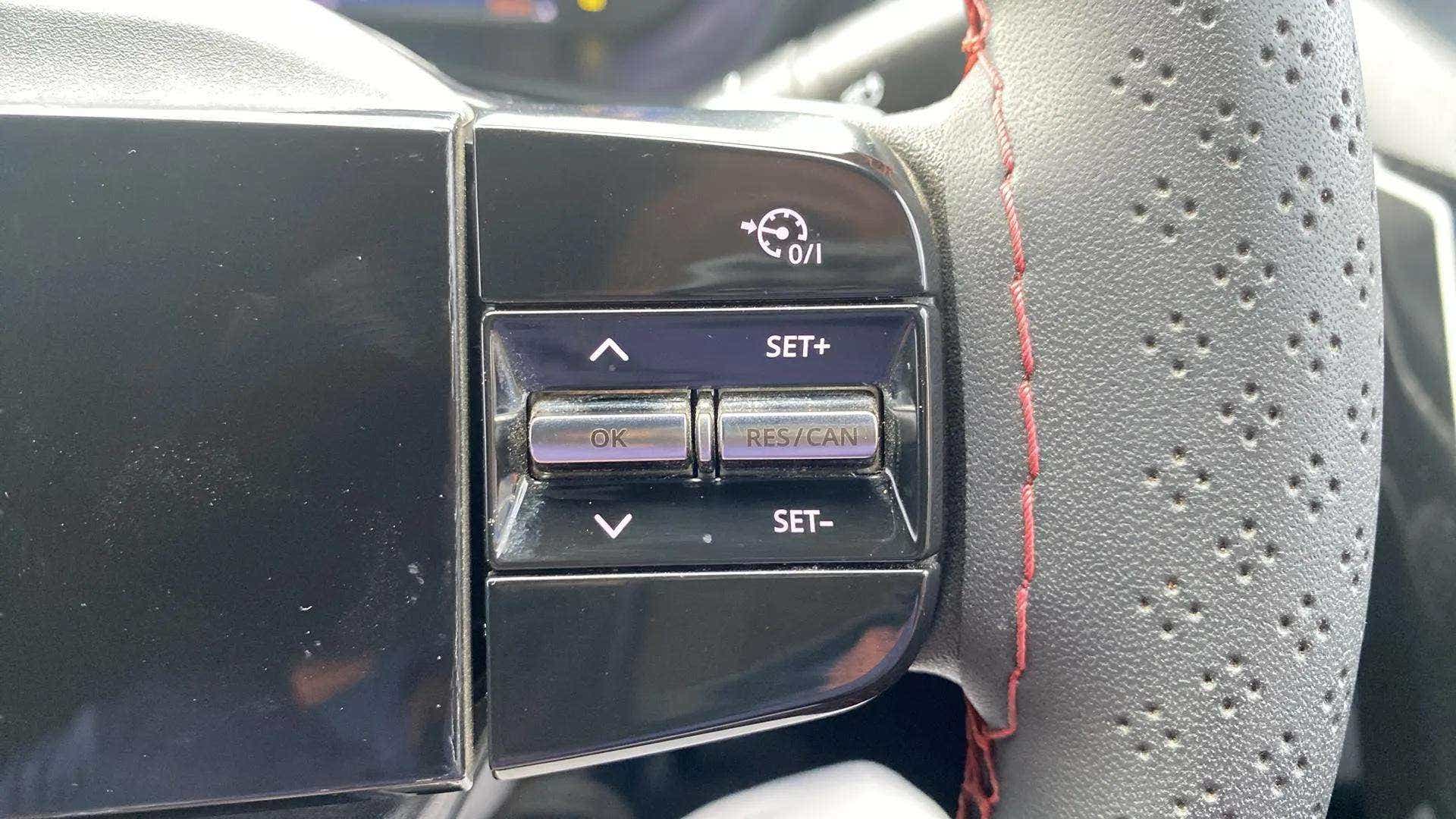 Steering wheel cruise control buttons of a Tata Nexon