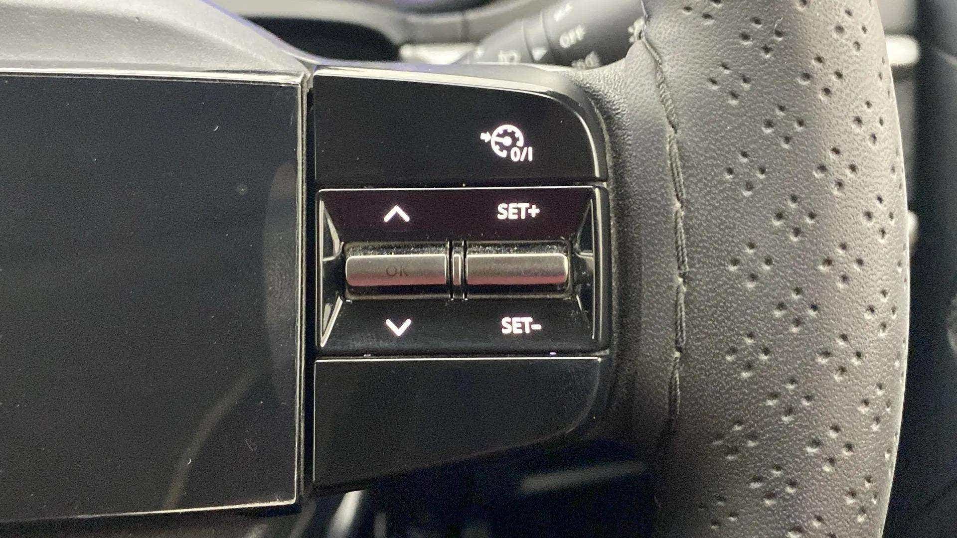 Close-up of steering wheel controls of a Tata Nexon