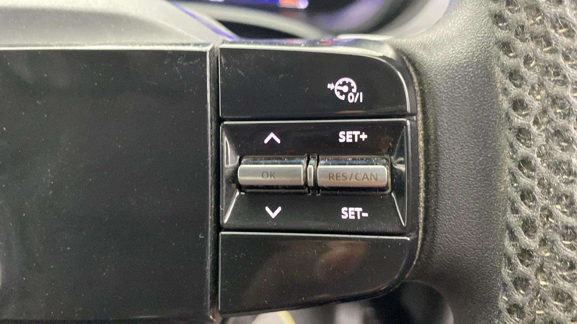 Steering wheel cruise control buttons of a Tata Nexon