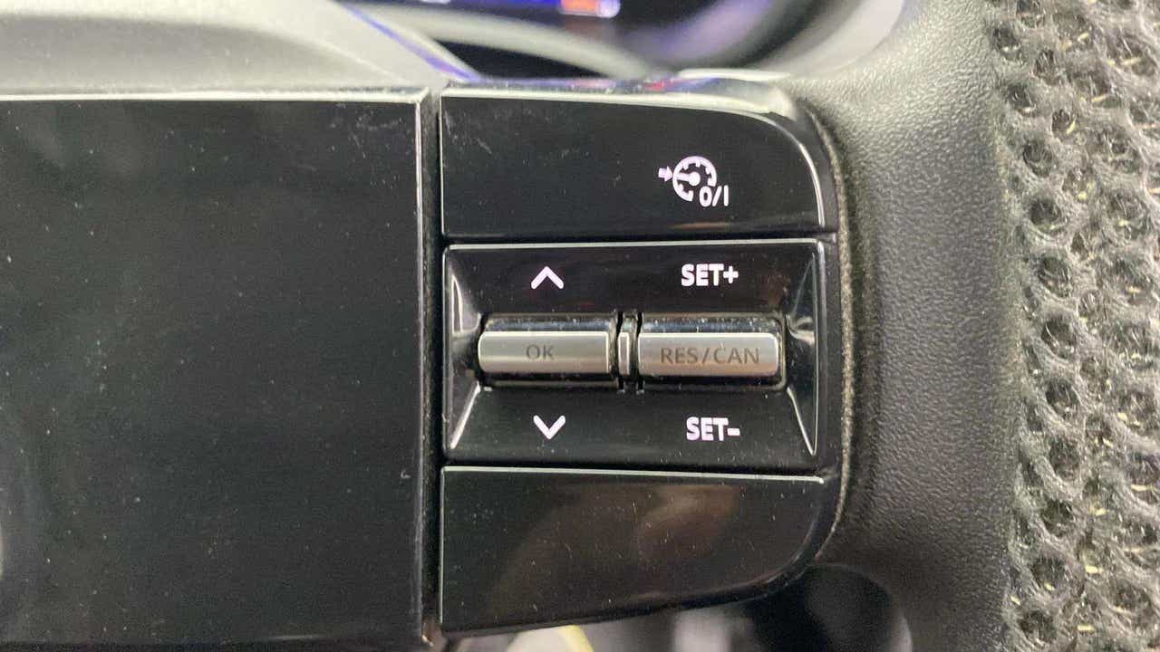 Steering wheel cruise control buttons of a Tata Nexon