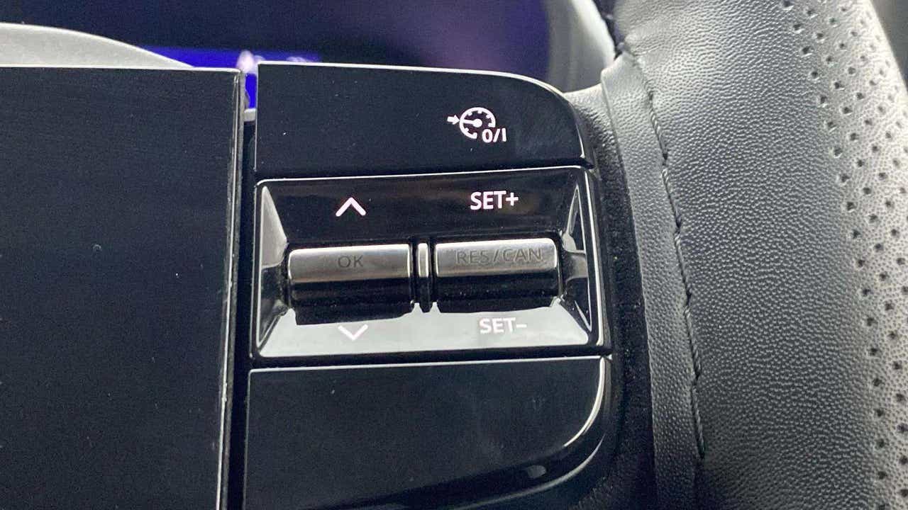 Steering wheel cruise control buttons of a Tata Nexon