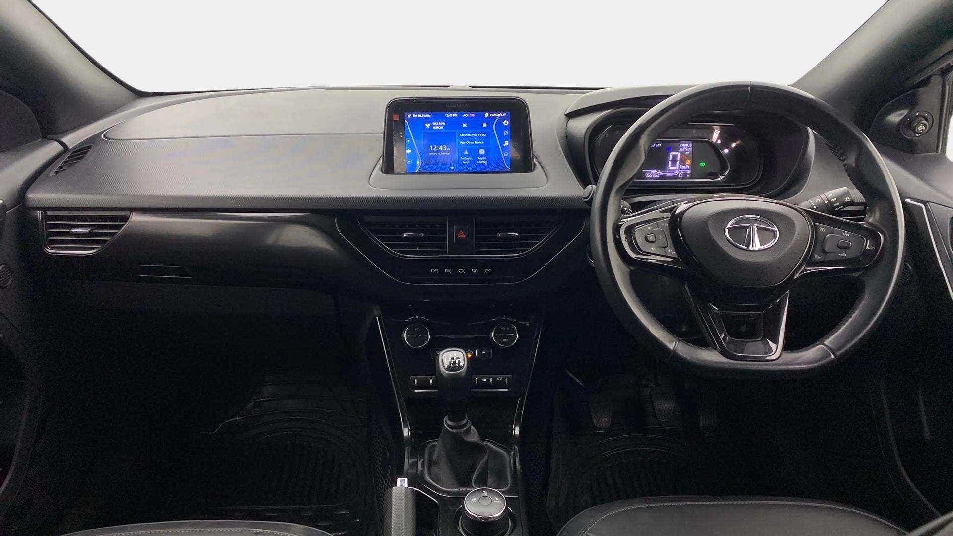 Dashboard and steering wheel view of a Tata Nexon 2017-2023