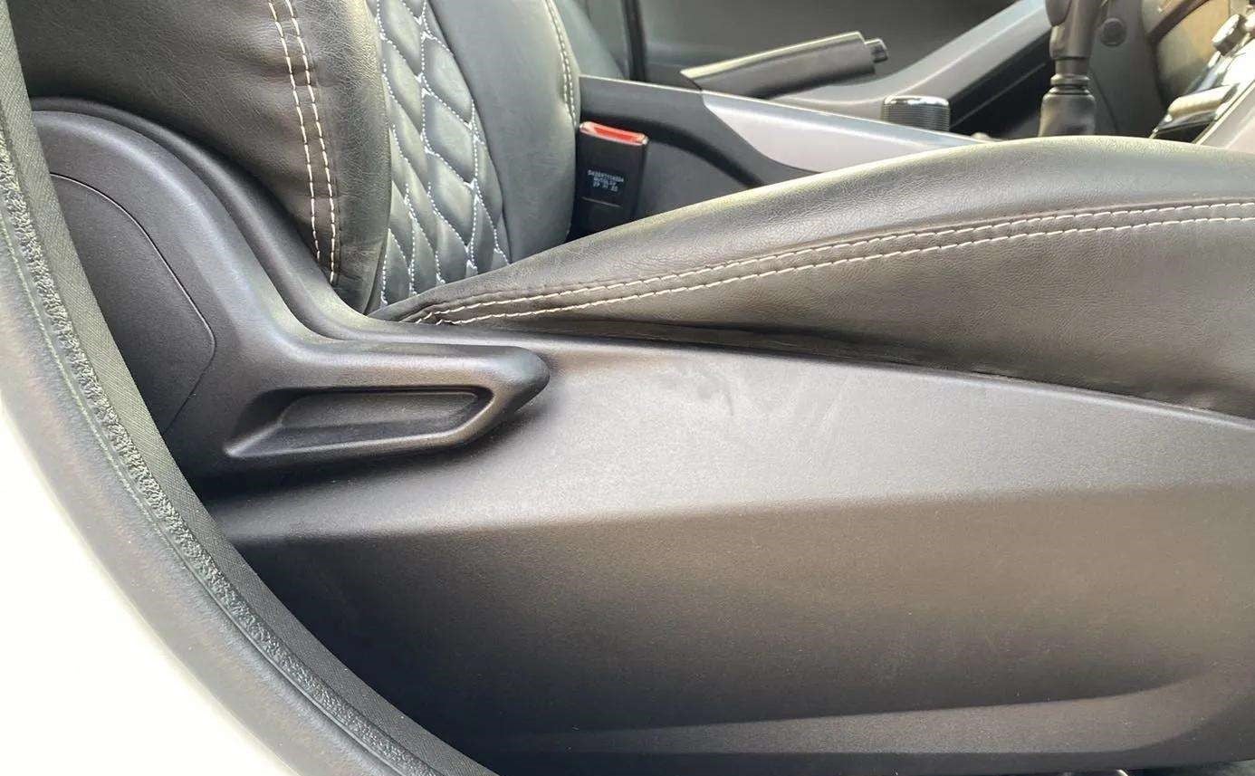 Close-up of a seat lever and upholstery in a Tata Nexon 2017-2023