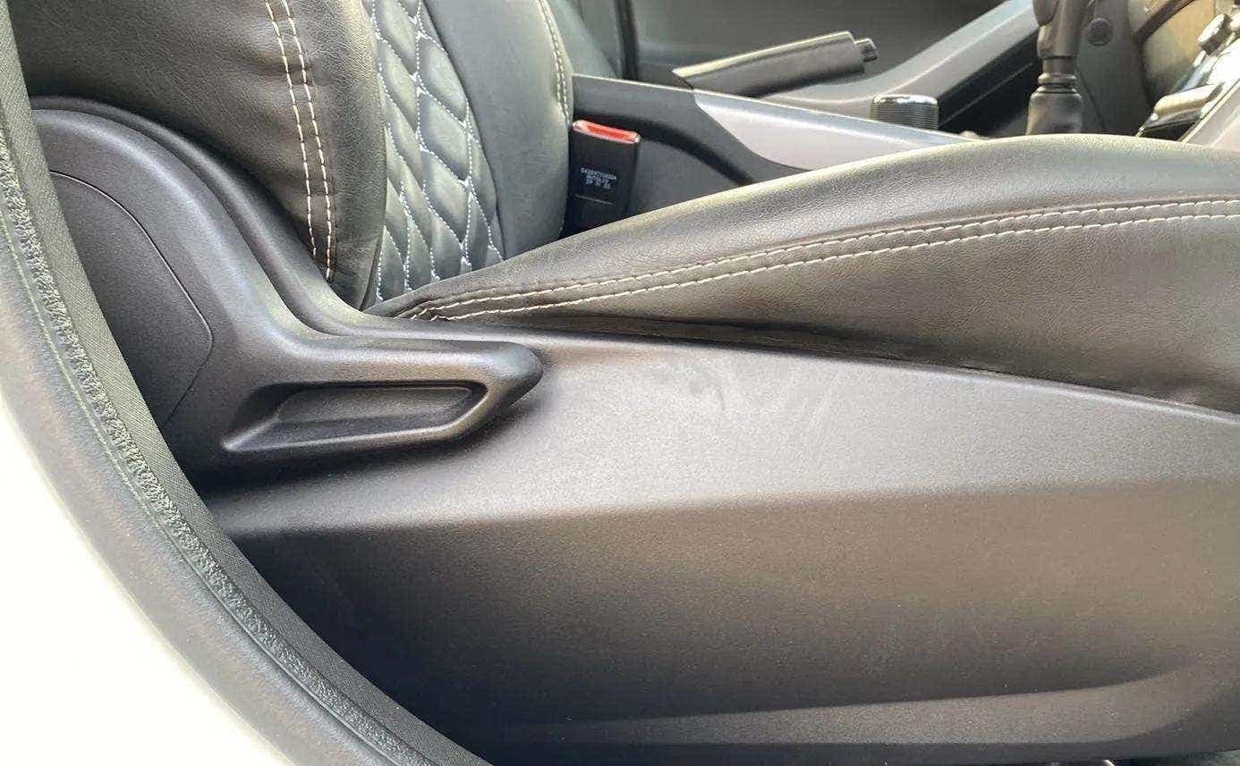 Close-up of a seat lever and upholstery in a Tata Nexon 2017-2023