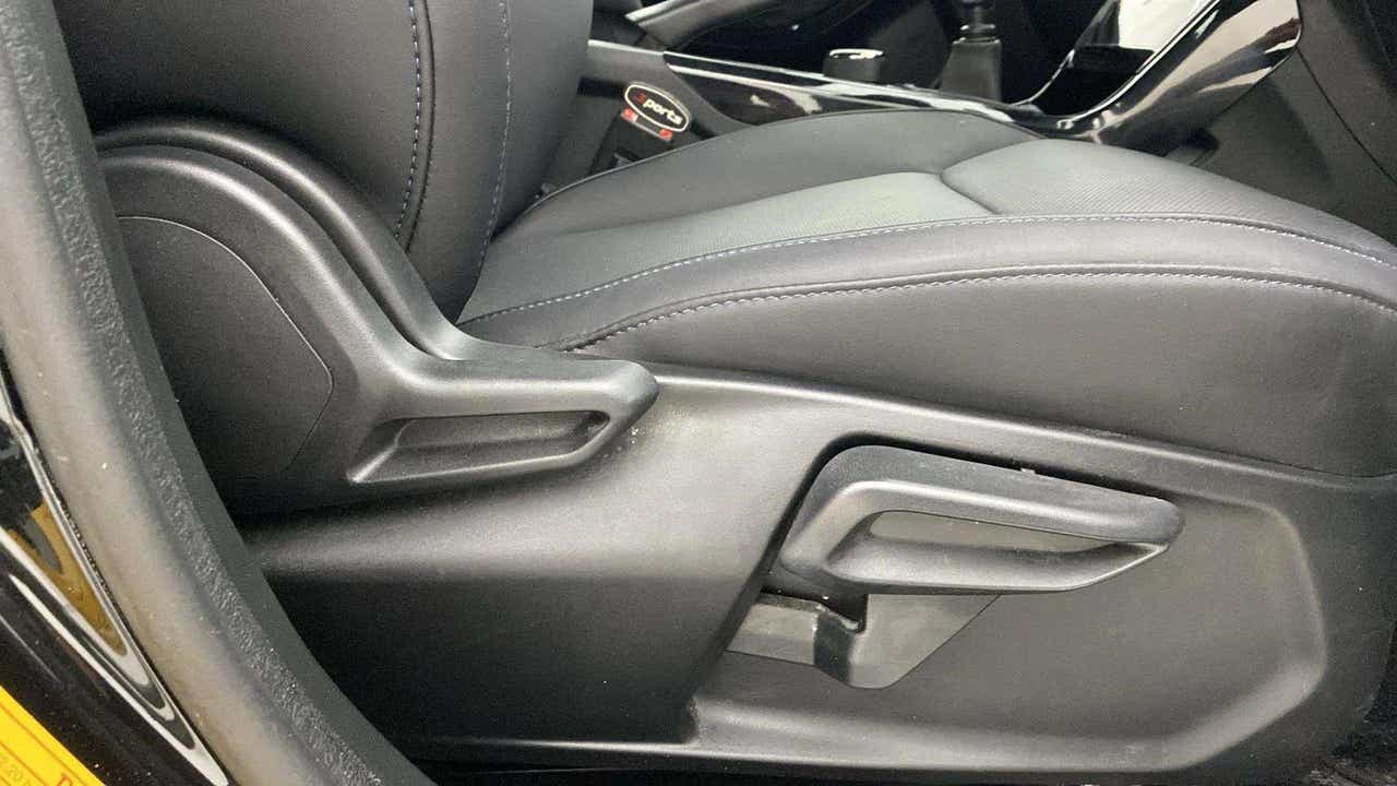 Close-up of front seat adjustment controls of a Tata Nexon