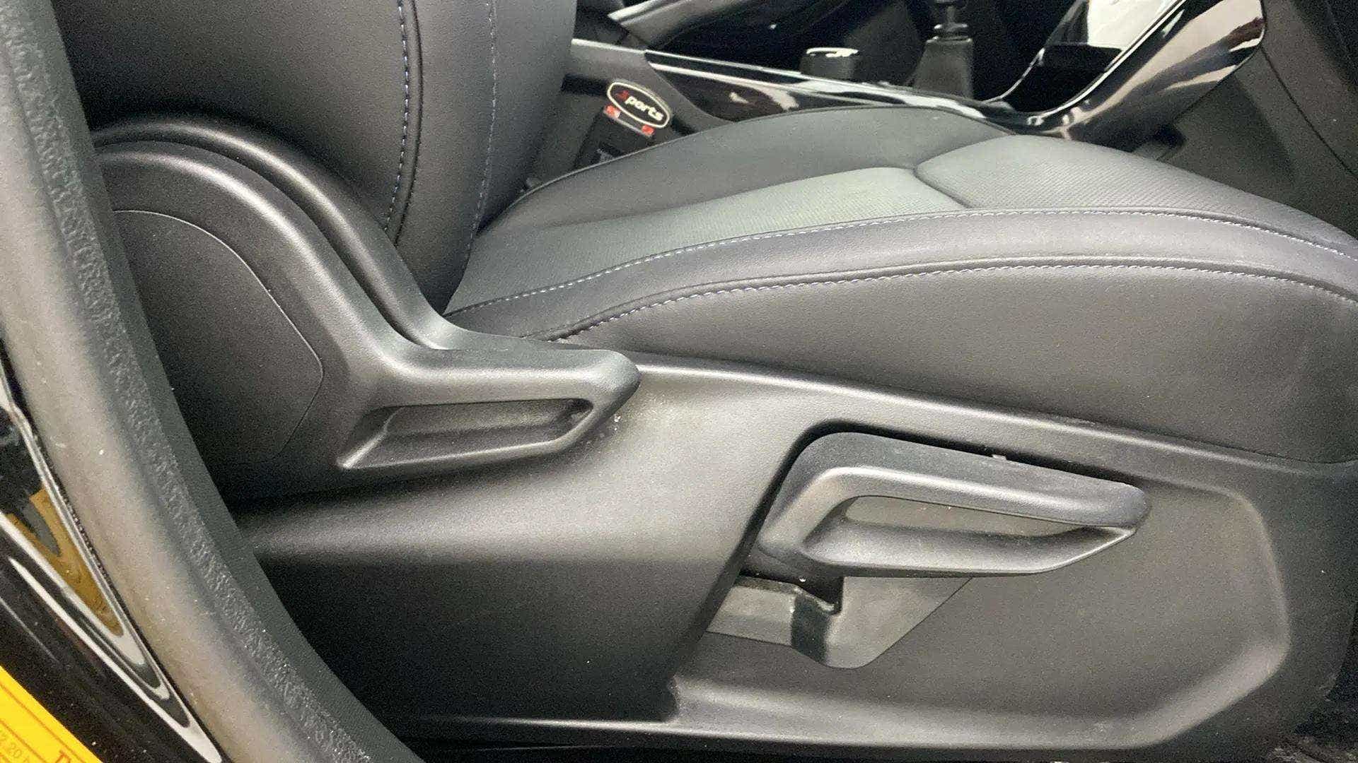 Close-up of front seat adjustment controls of a Tata Nexon