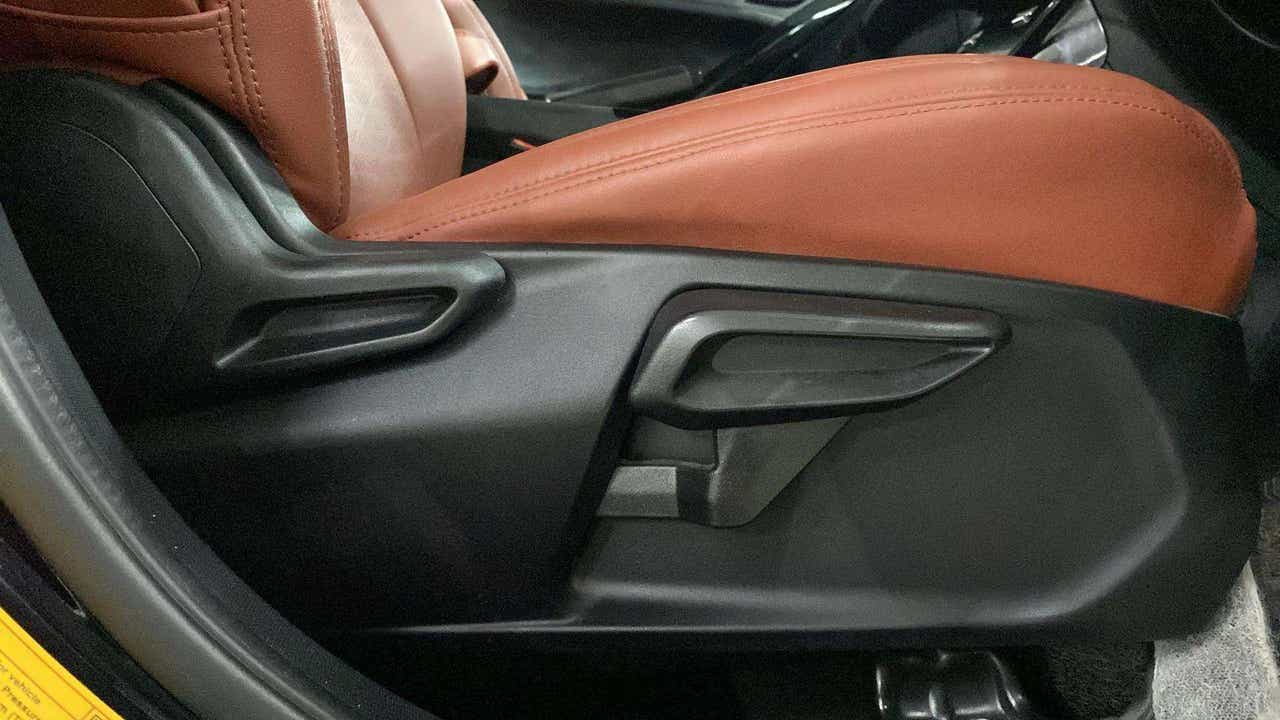 Close-up of front seat adjustment lever of a Tata Nexon