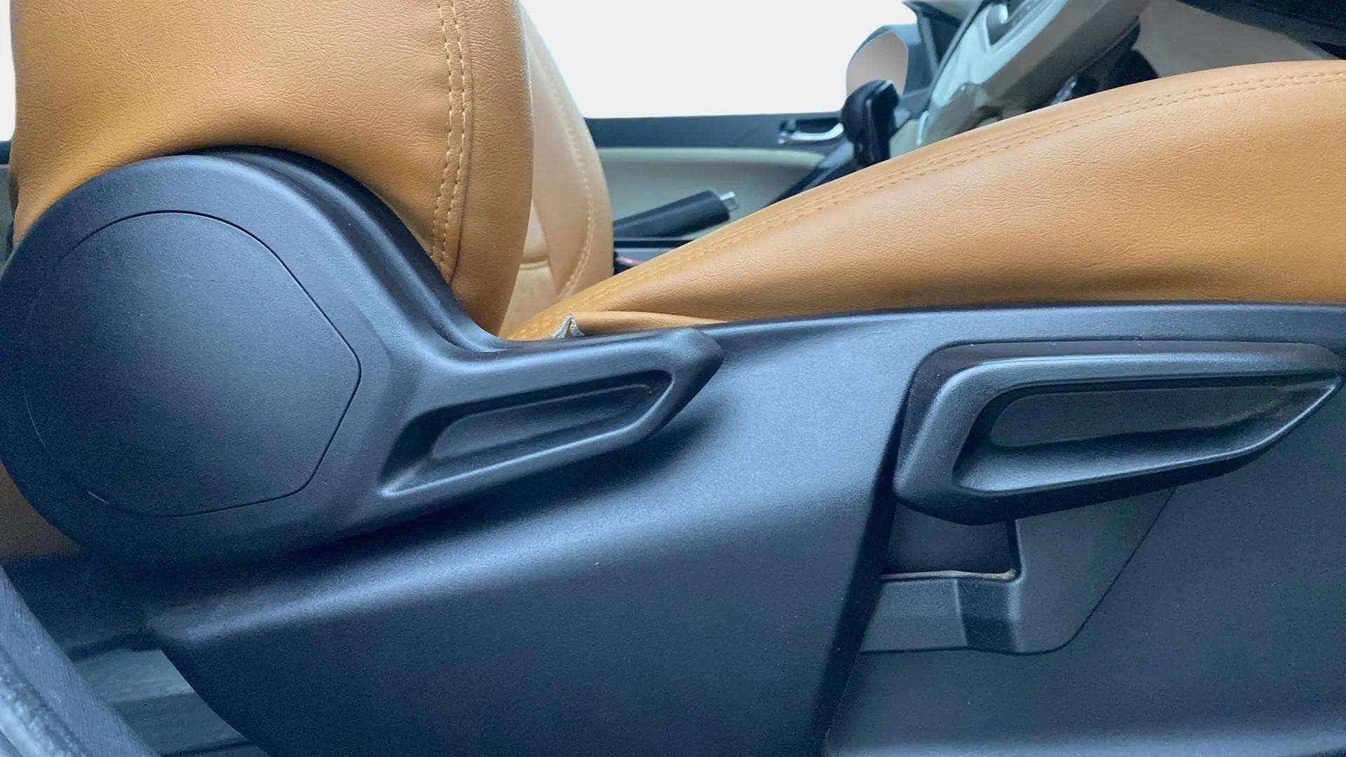 Close-up of the front seat adjustment lever of a Tata Nexon 2017-2023