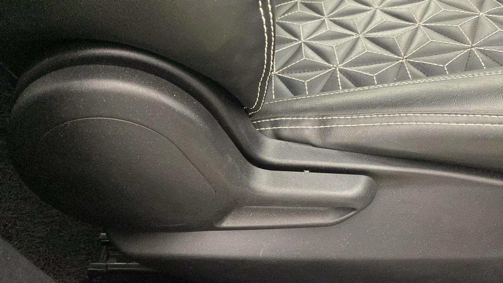 Close-up of a seat adjustment lever of a Tata Nexon 2017-2023