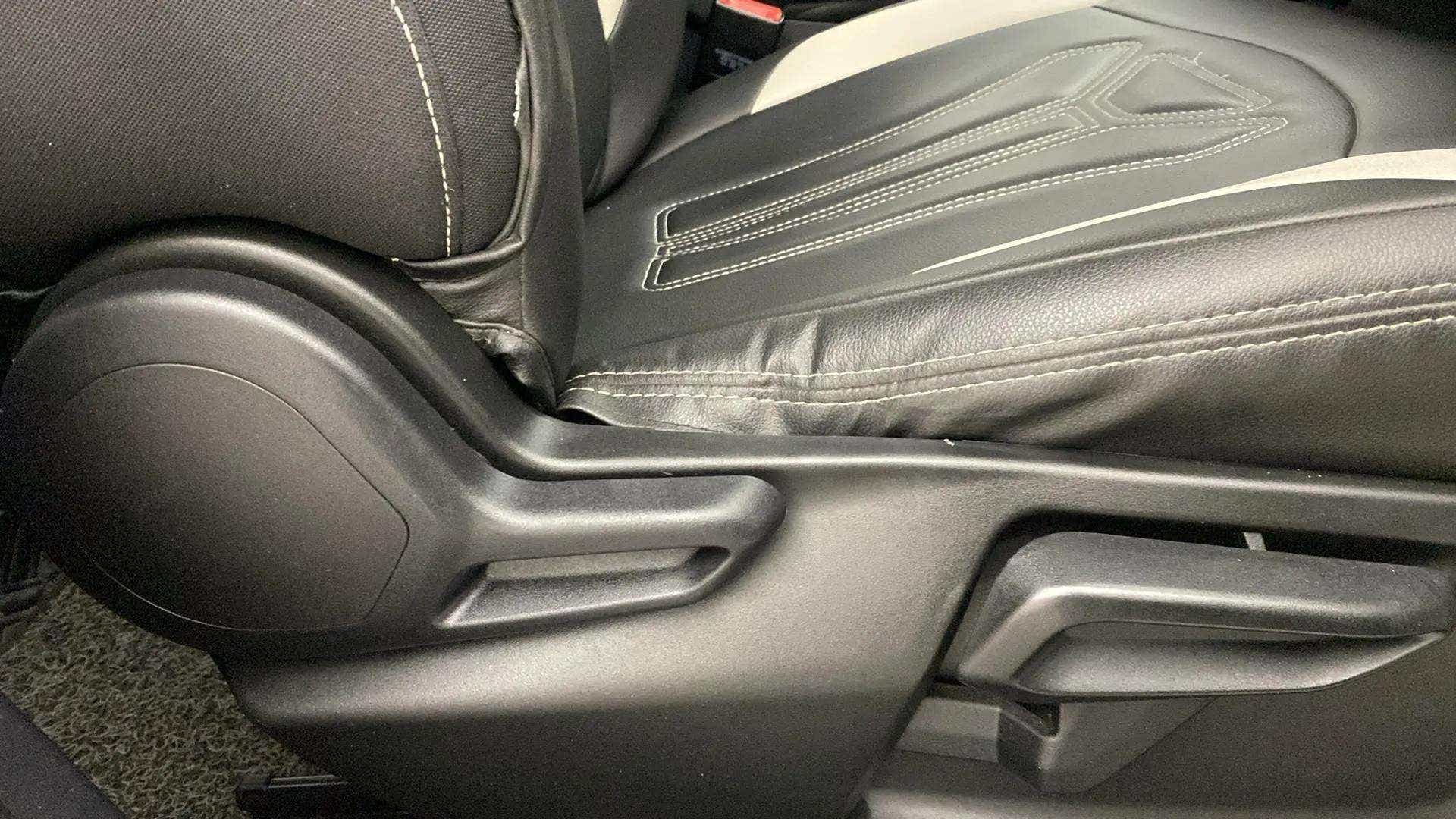 Side view of driver seat adjustment controls of a Tata Nexon 2017-2023