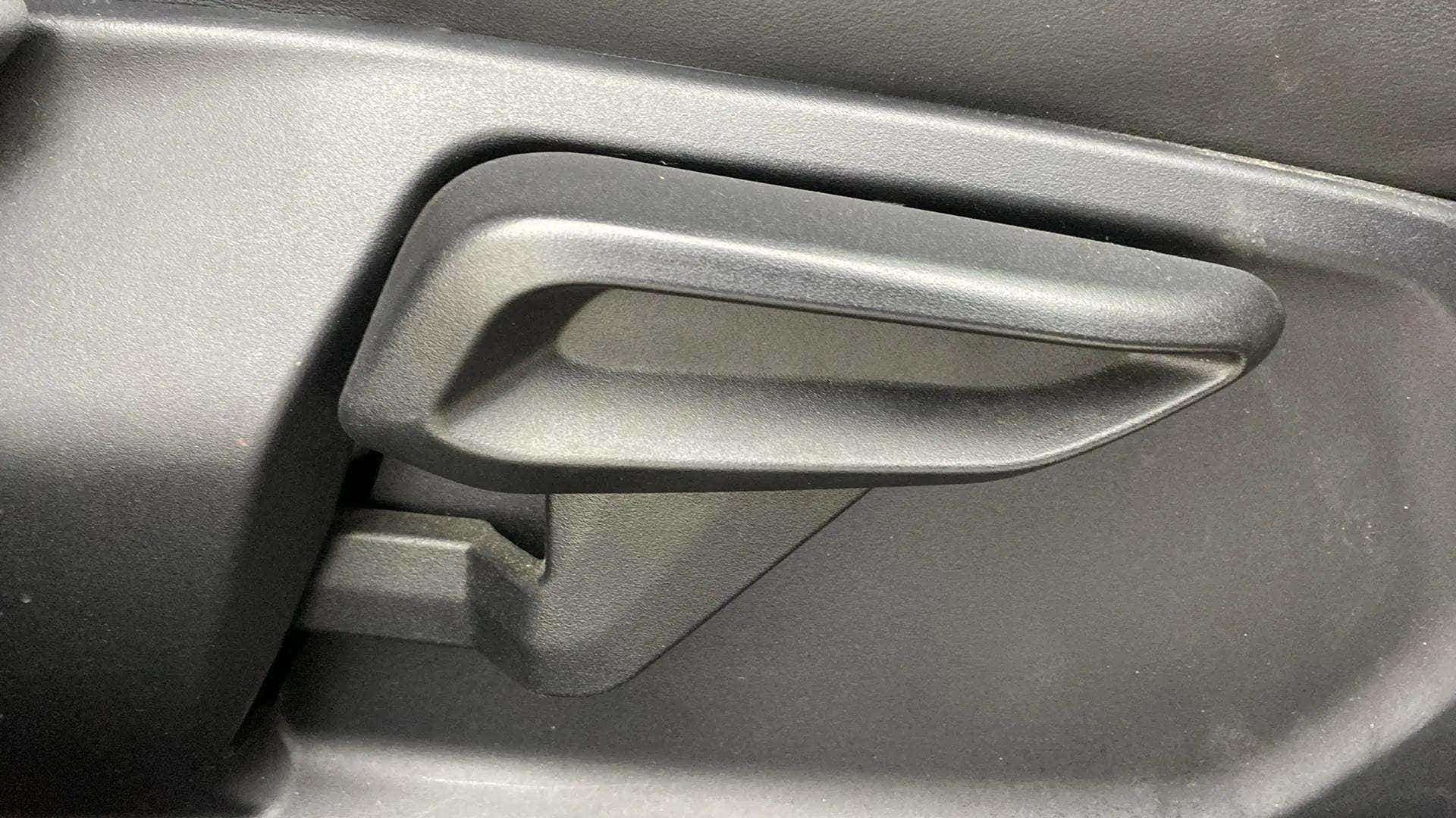 Close-up of interior door handle of a Tata Nexon