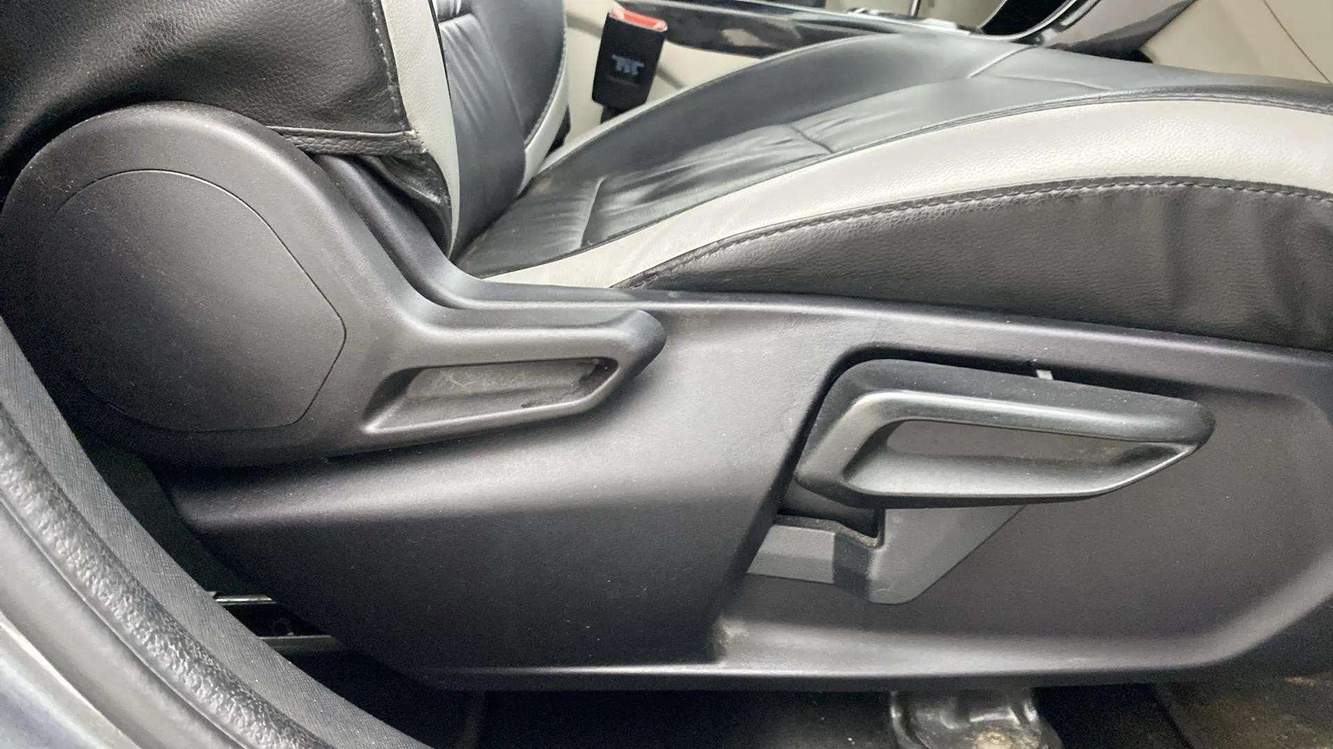 Side view of front seat adjustment lever of a Tata Nexon 2017-2023