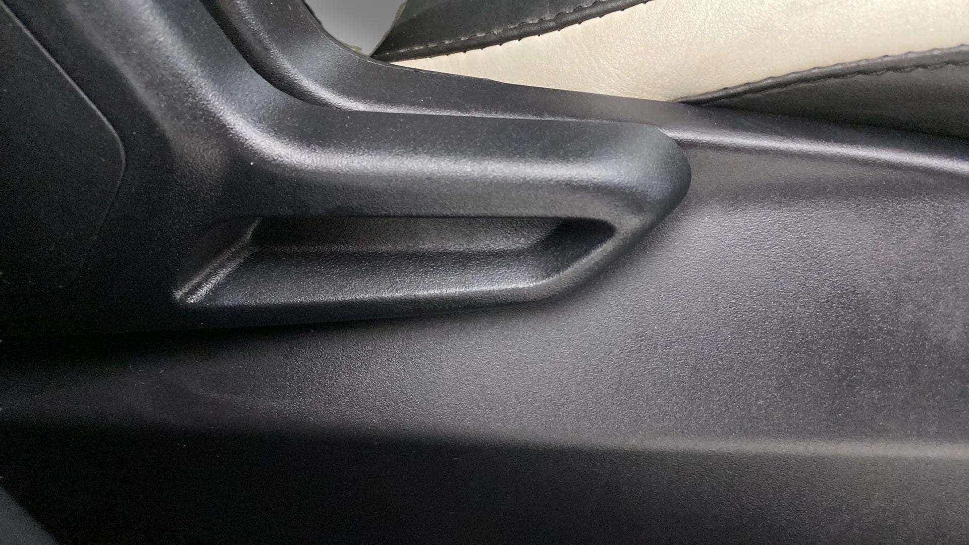 Close-up of a seat adjustment lever of a Tata Nexon 2017-2023