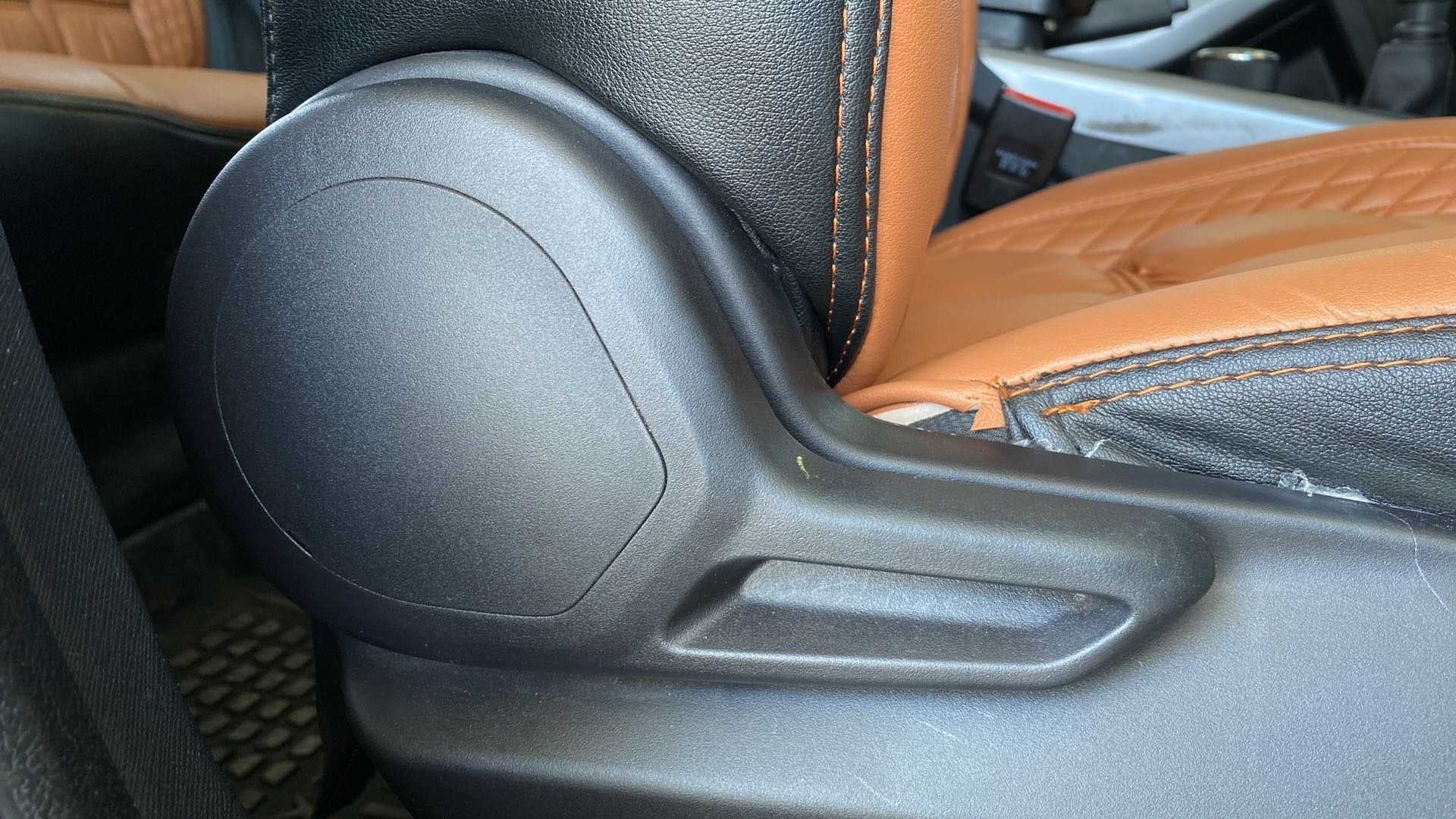 Seat adjustment lever and stitching detail of a Tata Nexon 2017-2023